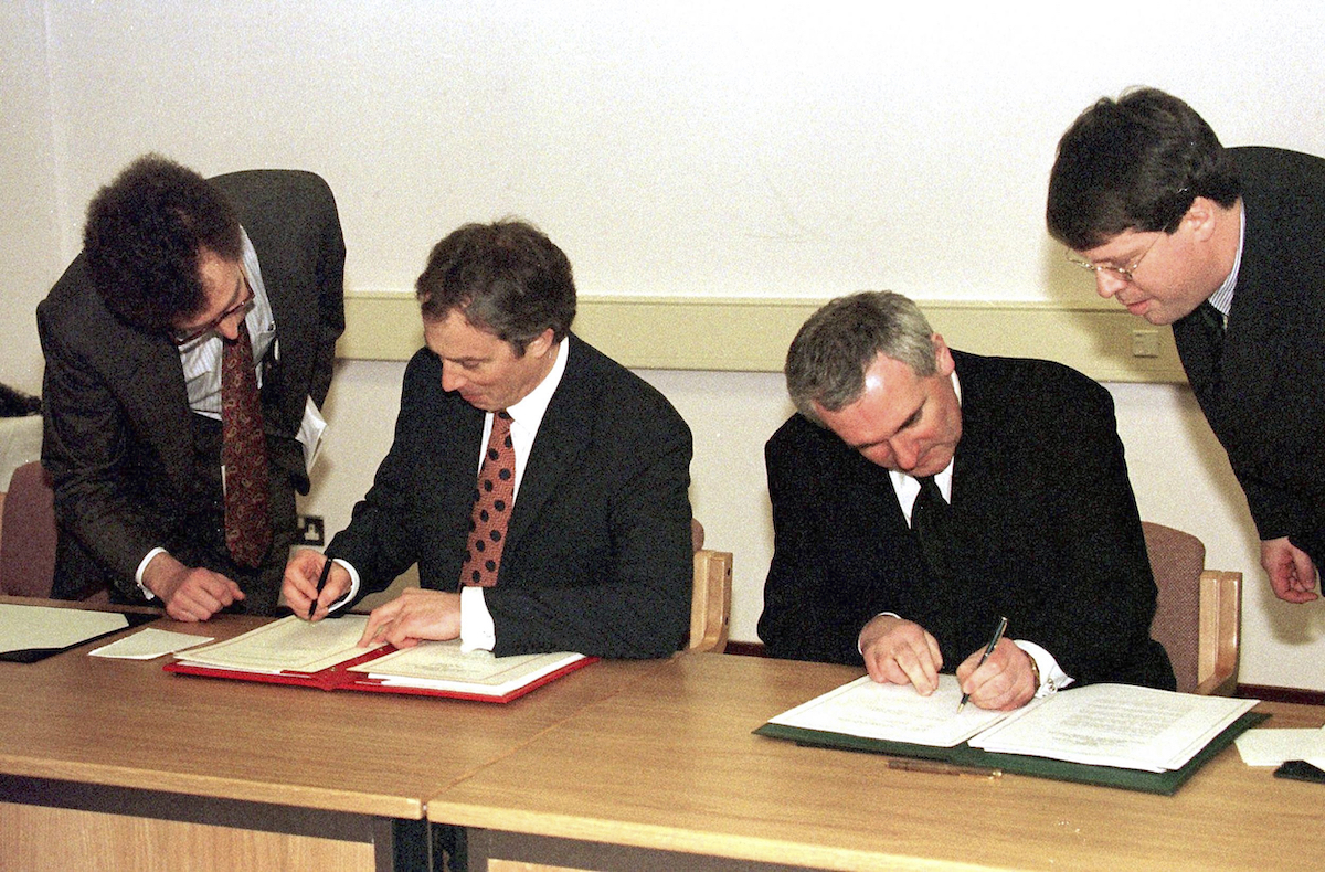 Former prime minister Sir Tony Blair and then taoiseach Bertie Ahern sign the Good Friday agreement 25 years ago.