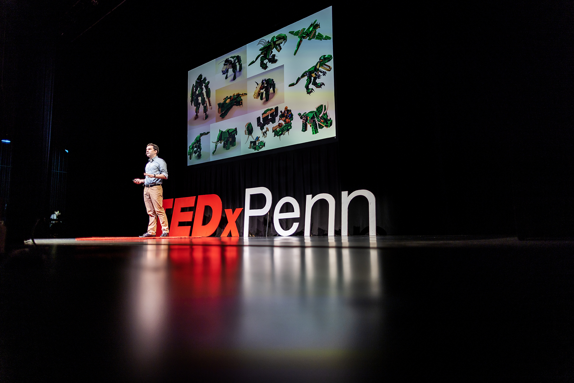 Devin Carroll in front of TEDxPenn sign