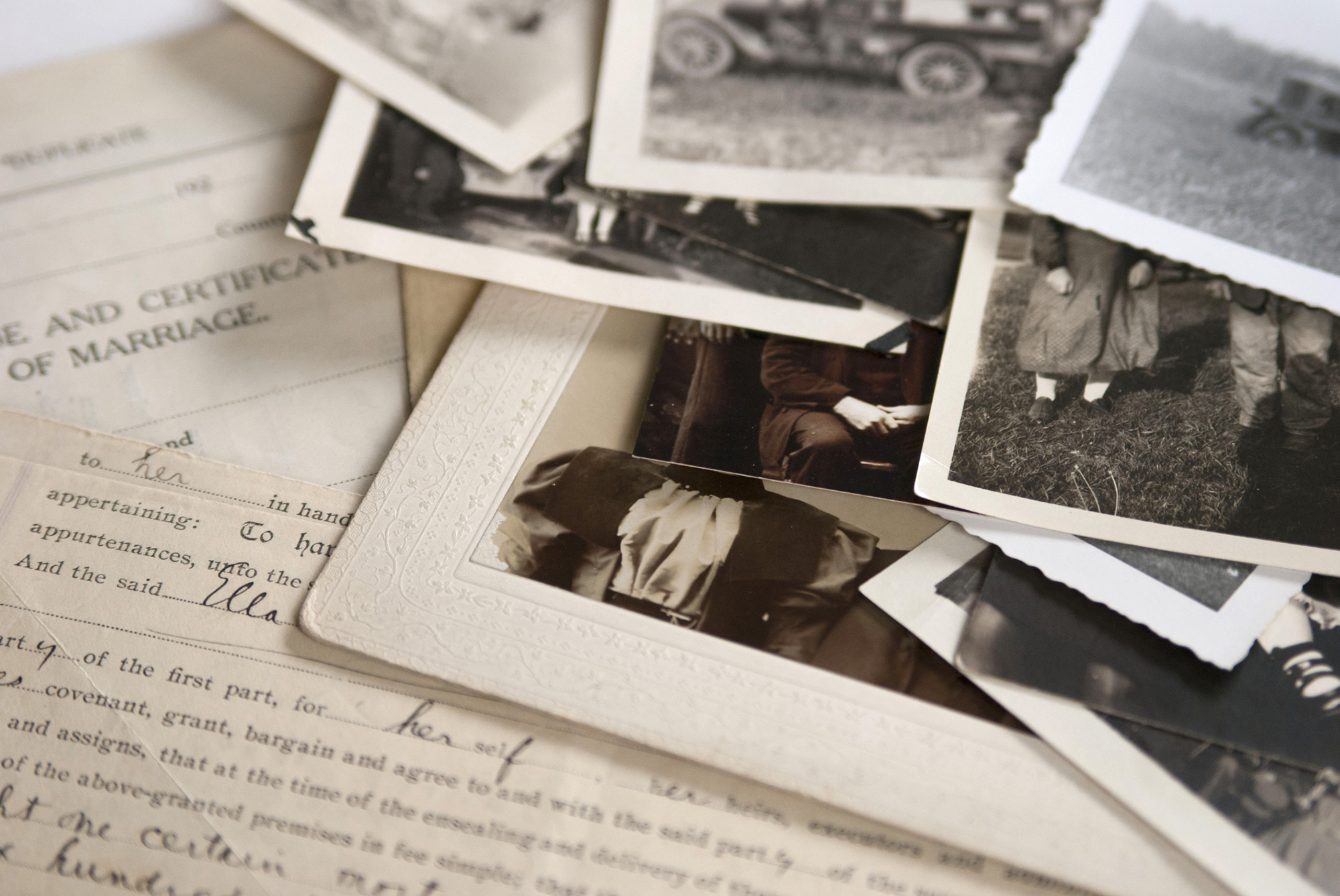 A pile of old family photographs and documents.