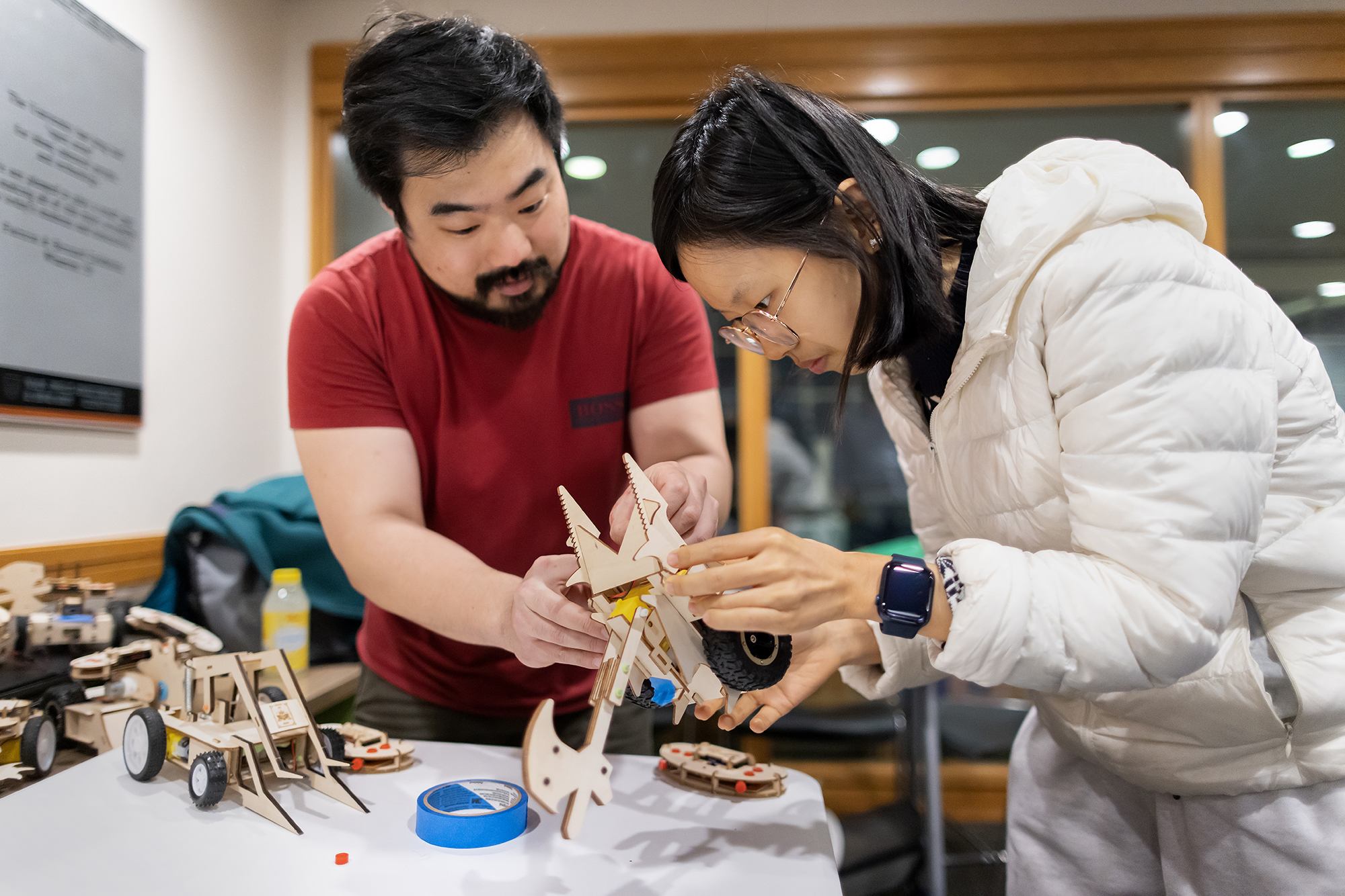 workers in the education commons construct battle bots