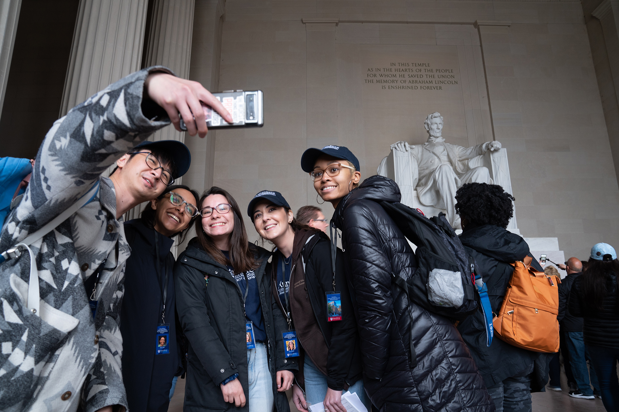 students taking a selfie at the Lincoln memorial