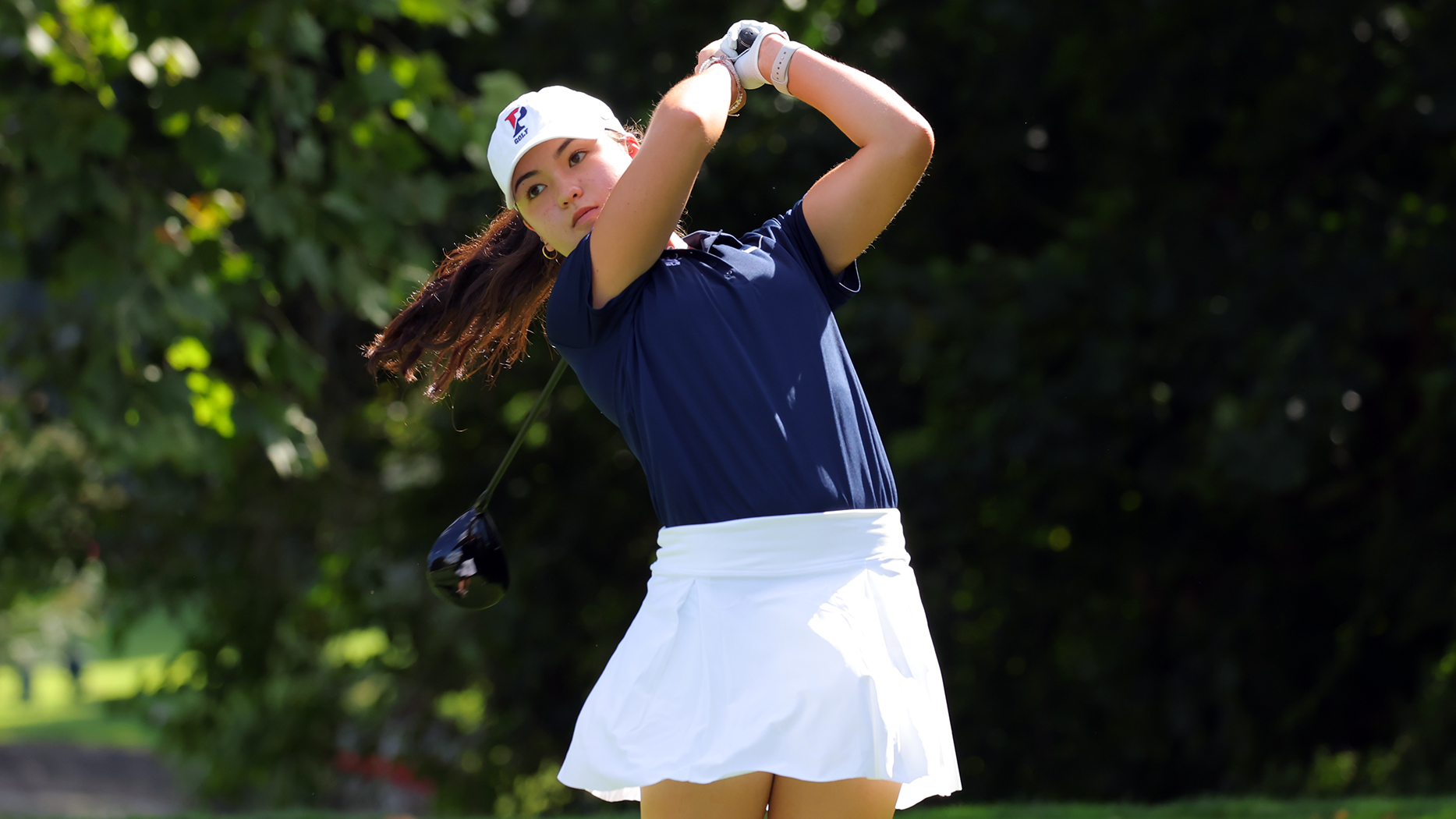 Bridget O’Keefe holds her club behind her head after finishing her swing.
