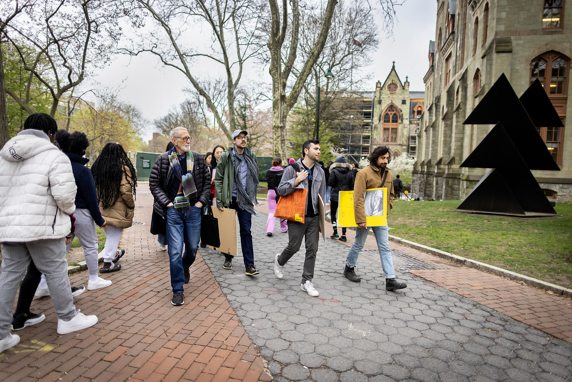Laurie Olin and members of his class walk with drawing supplies down Locust Walk.