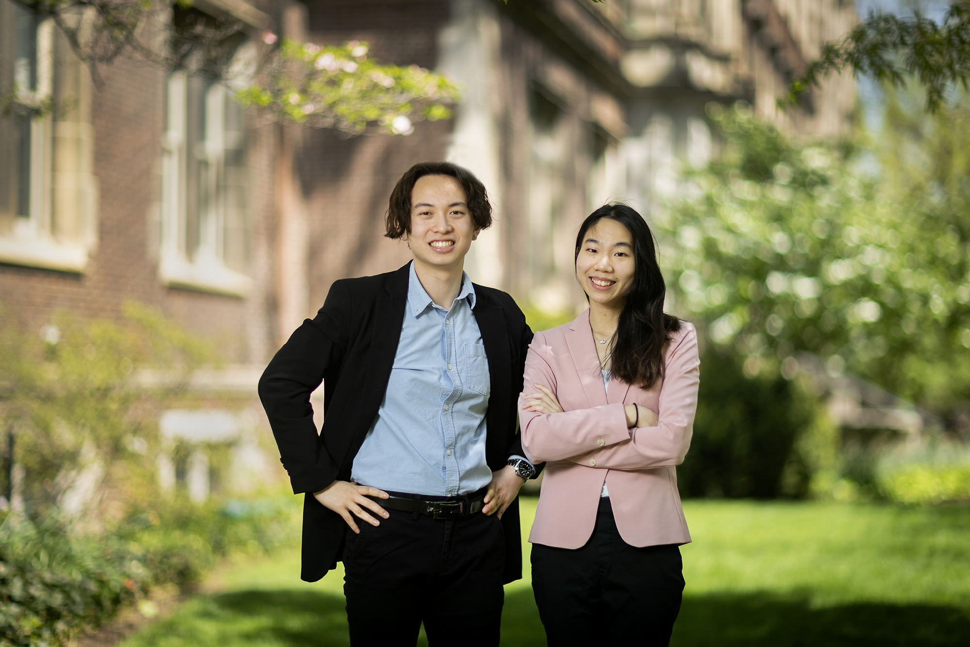 Kenneth Pham and Catherine Chang pose in business suites.