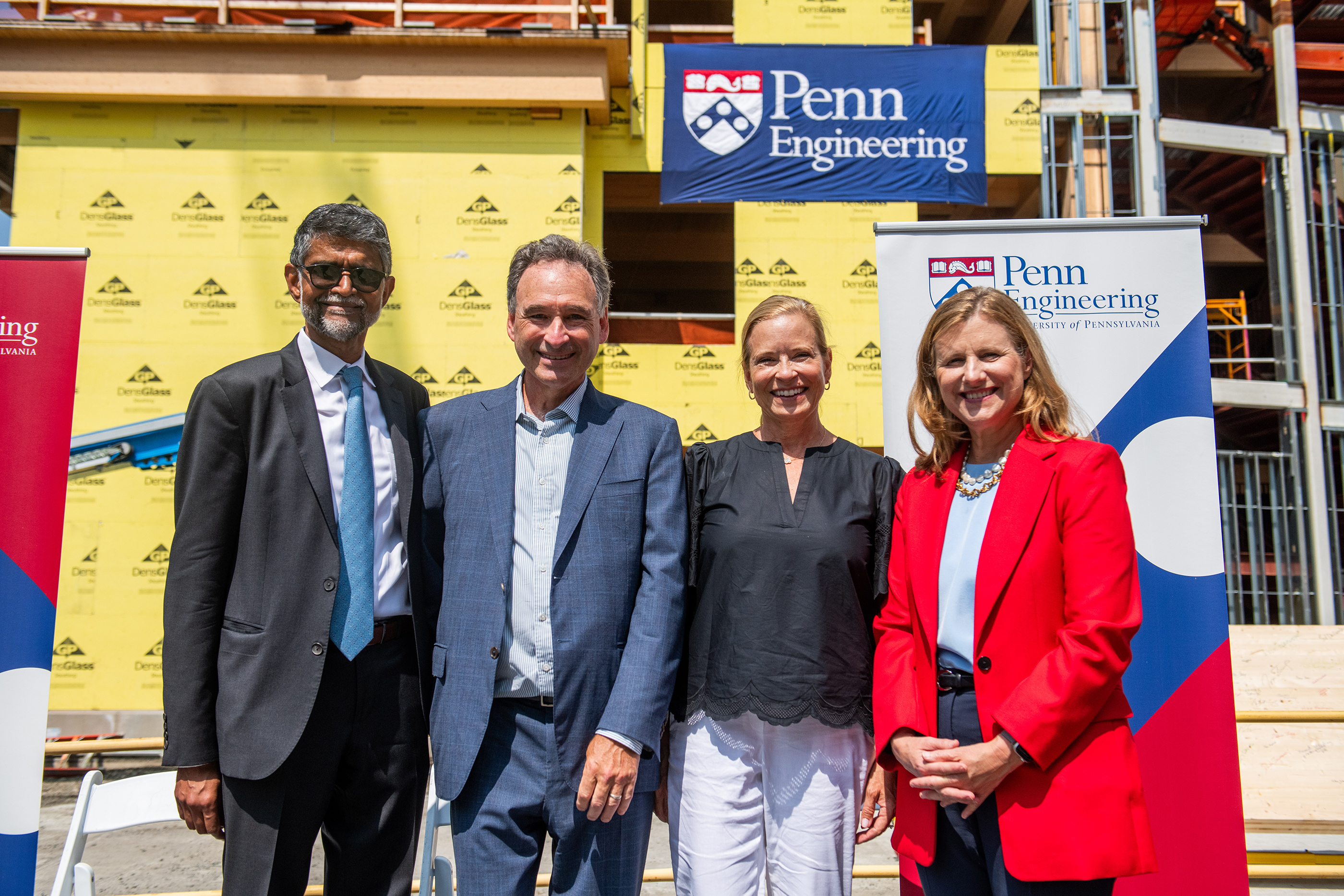Kumar, Stone, Stone, and Magill smile for a photo in front of AG Hall with Penn Engineering sign in background