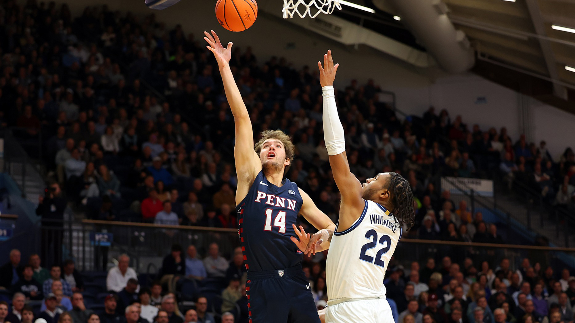 Max Martz goes up for the layup while a Villanova defender attempts to block the shots.