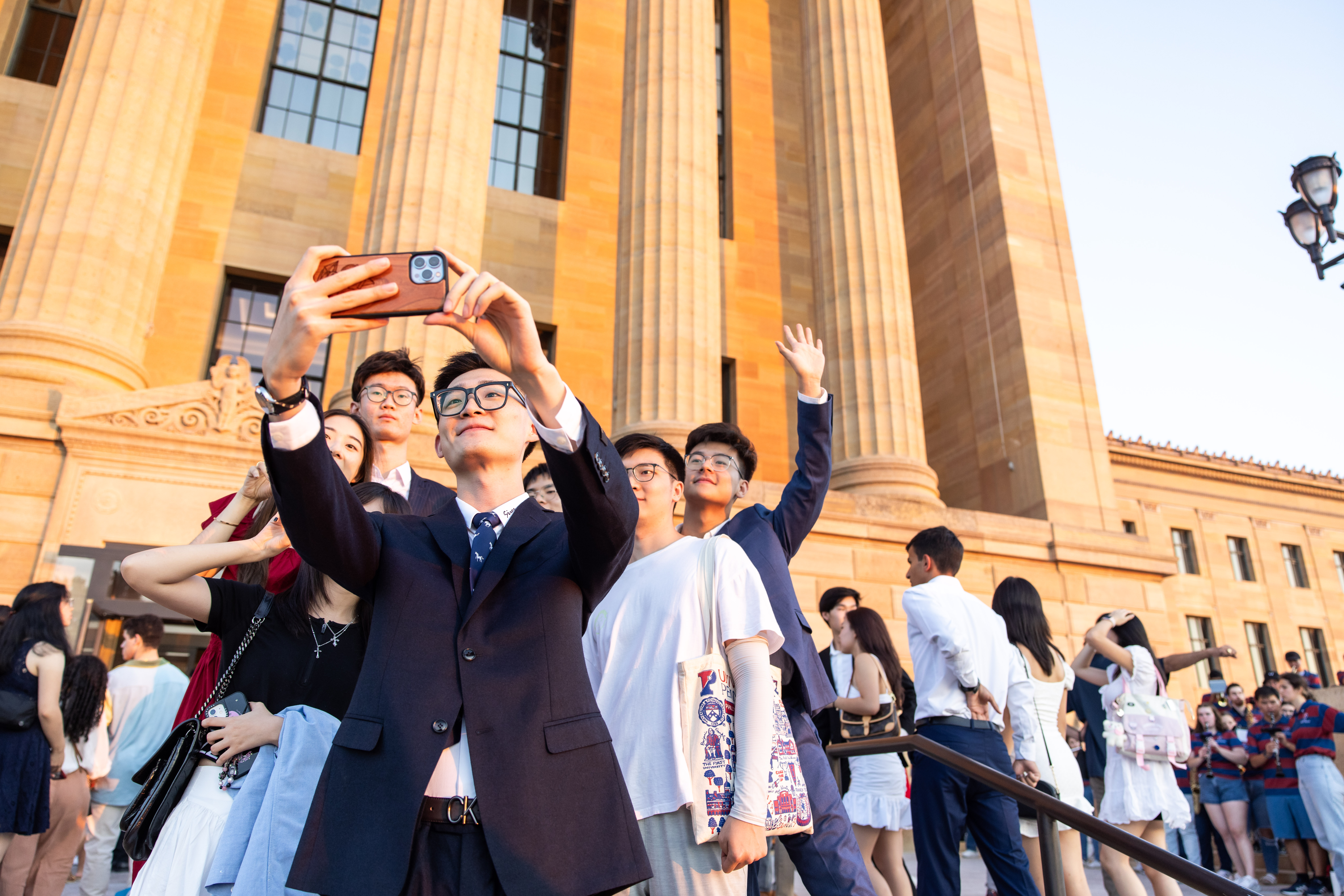 A student takes a group selfie in front of the Philadelphia Museum of Art