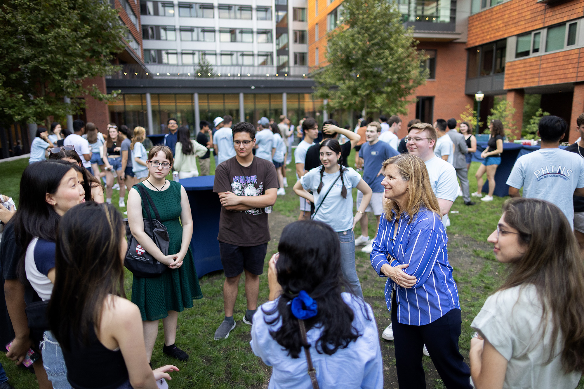 Liz Magill speaks with a circle of transfer students near Gutmann College House