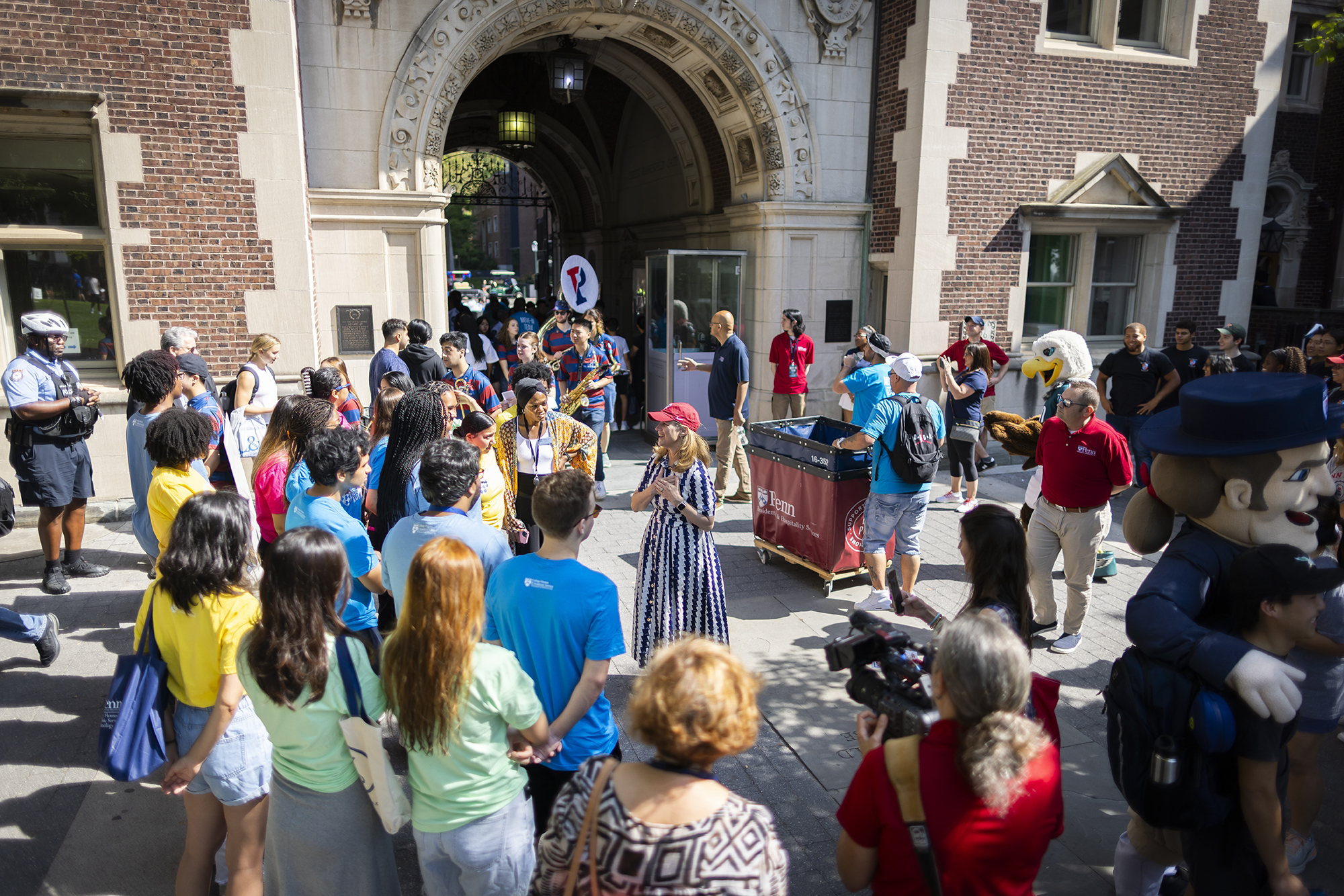 Penn President Liz Magill and a crowd of people on the Quadrangle on Move-In Day.
