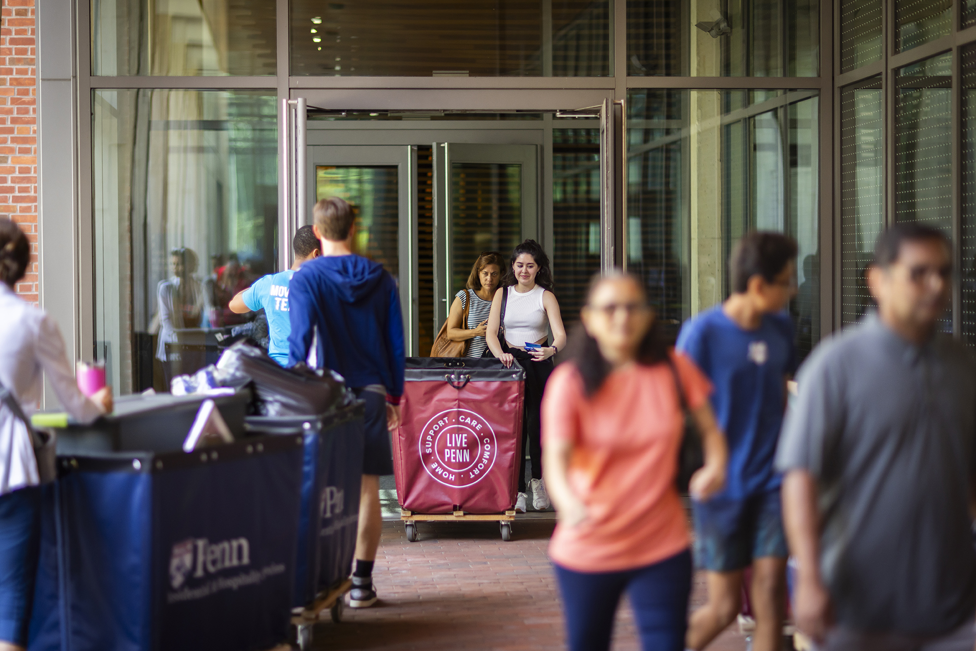 People moving into a Penn dorm with Move-In bins.