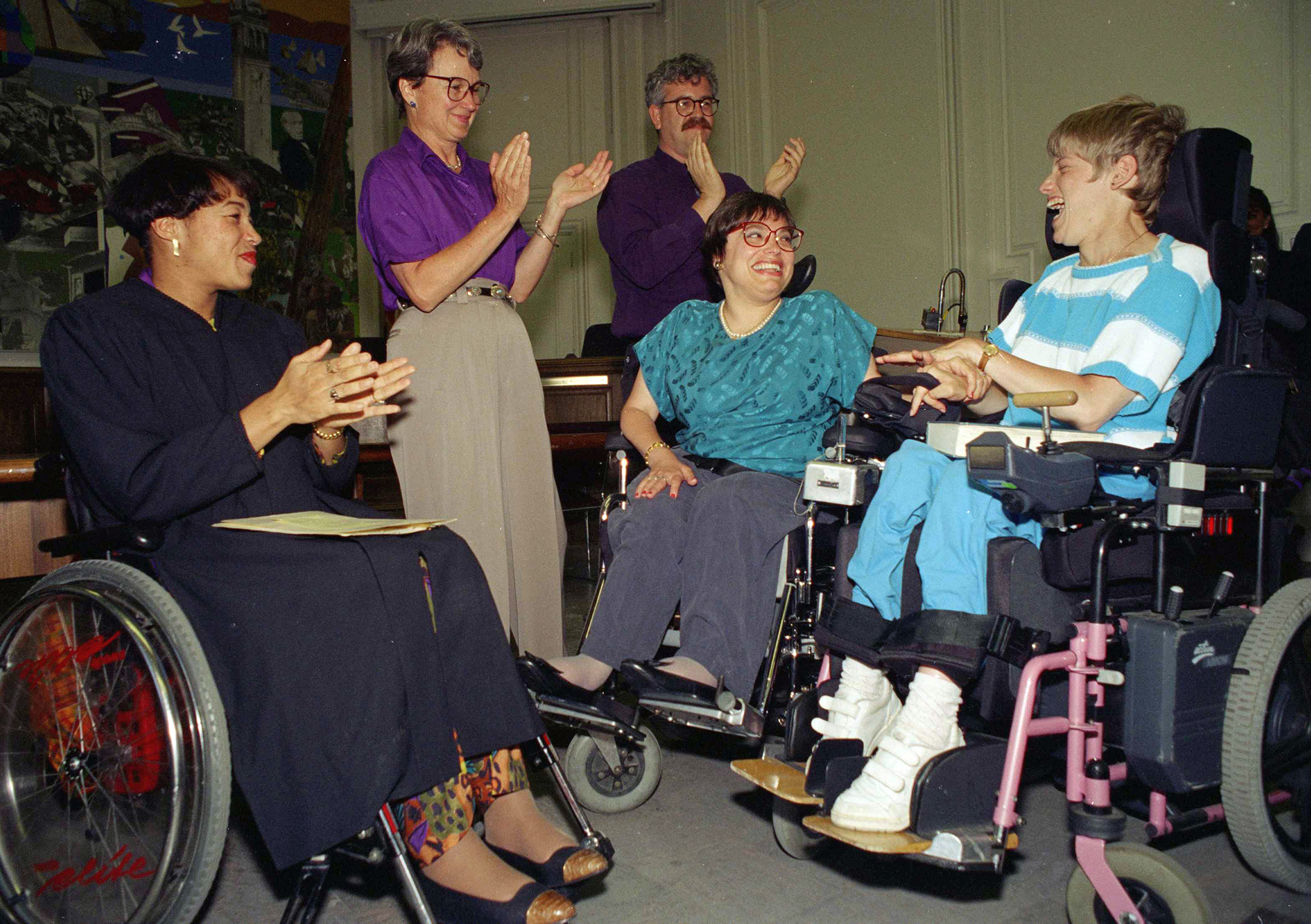 Judy Heumann is applauded during her swearing-in as U.S. Assistant Secretary for Special Education and Rehabilitative Service in 1993. 
