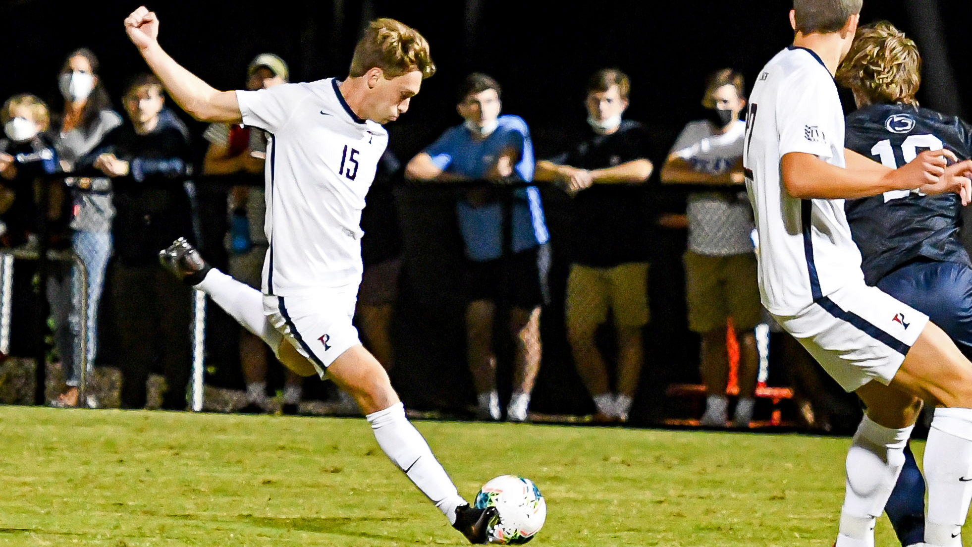 Against Penn State, Michael Hewes draws his foot back and prepares to kick the ball.