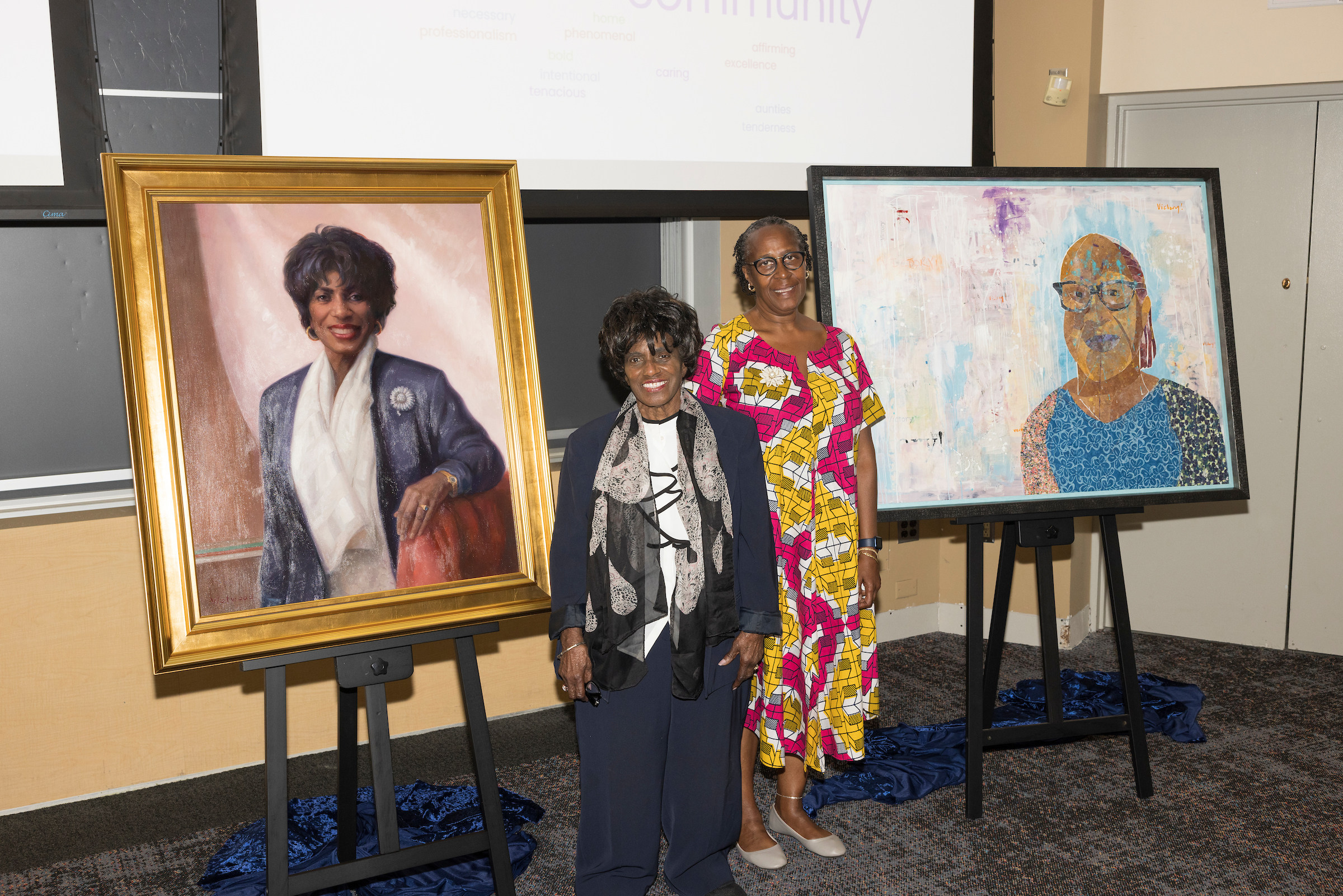 Cora Ingrum and Donna Hamptton pose beside their painted portraits.