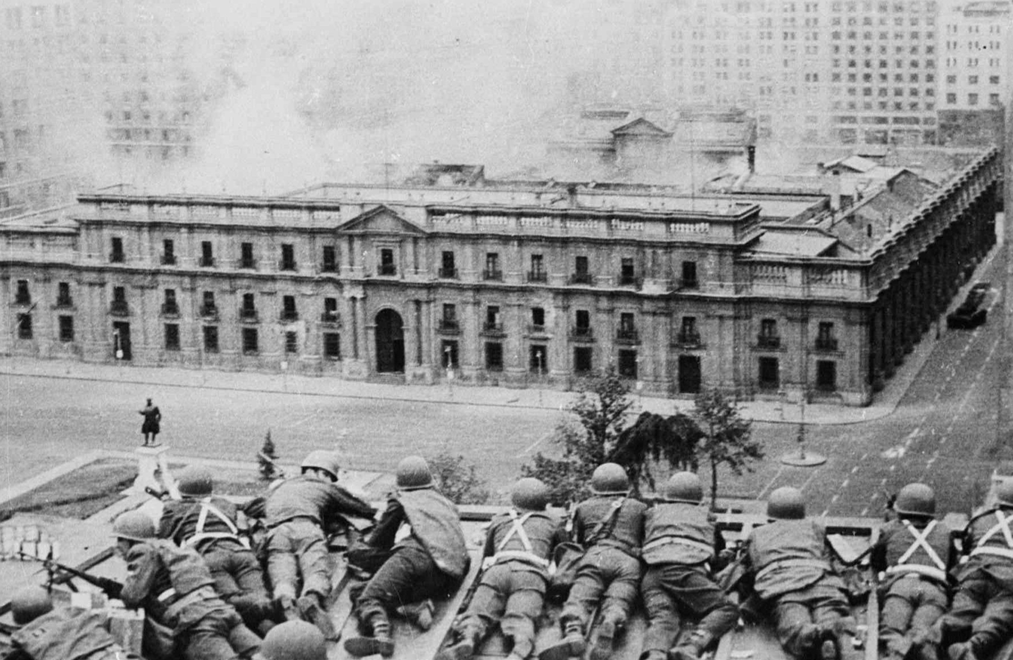 A row of soldiers lying on their stomachs take cover as La Moneda, the Chilean presidential palace, is bombed. 