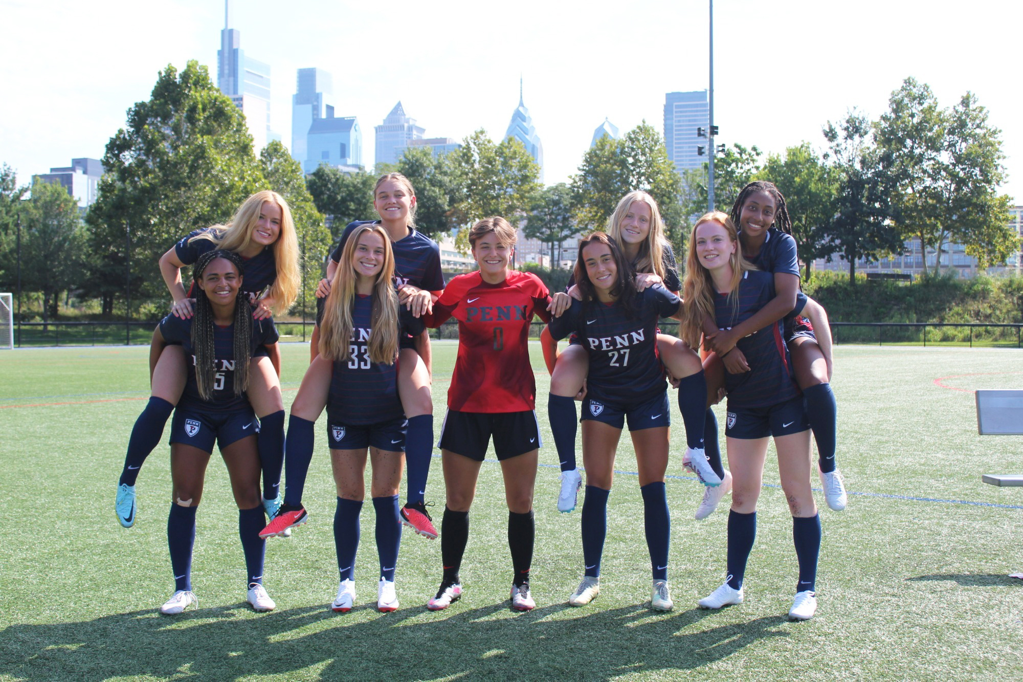 Seniors on the women's soccer team pose at Penn Park.
