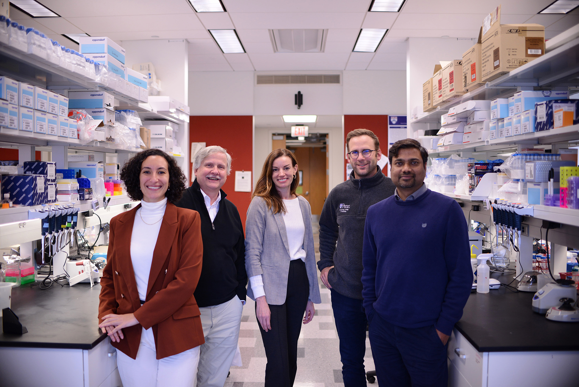 Five people standing in a lab.