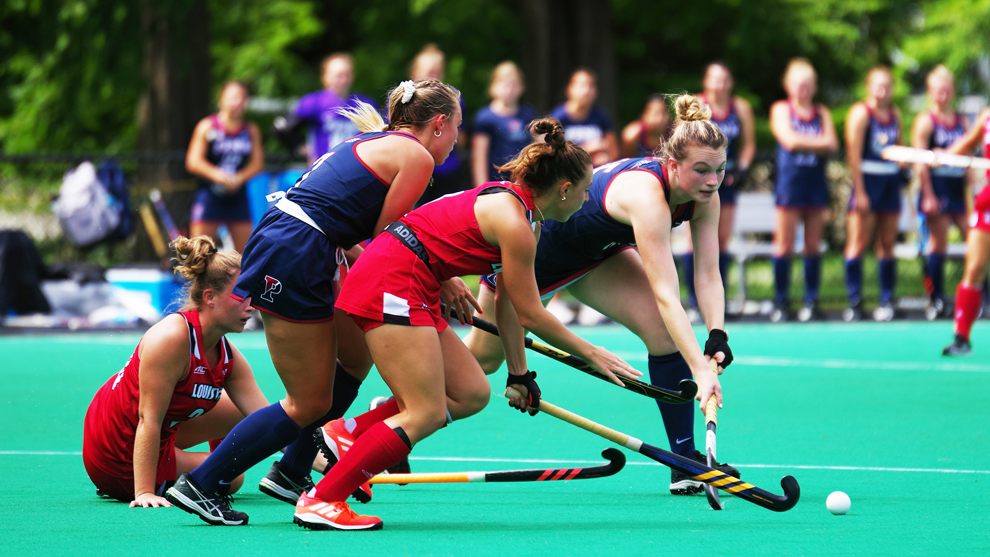 Allison Kuzyk fights for the ball with her stick in a game against Louisville.