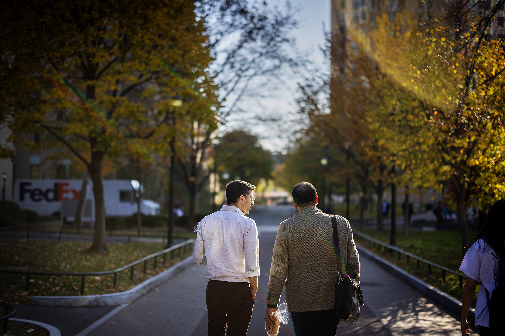 Harun Kucuk and Josh Teplitsky walk on campus.