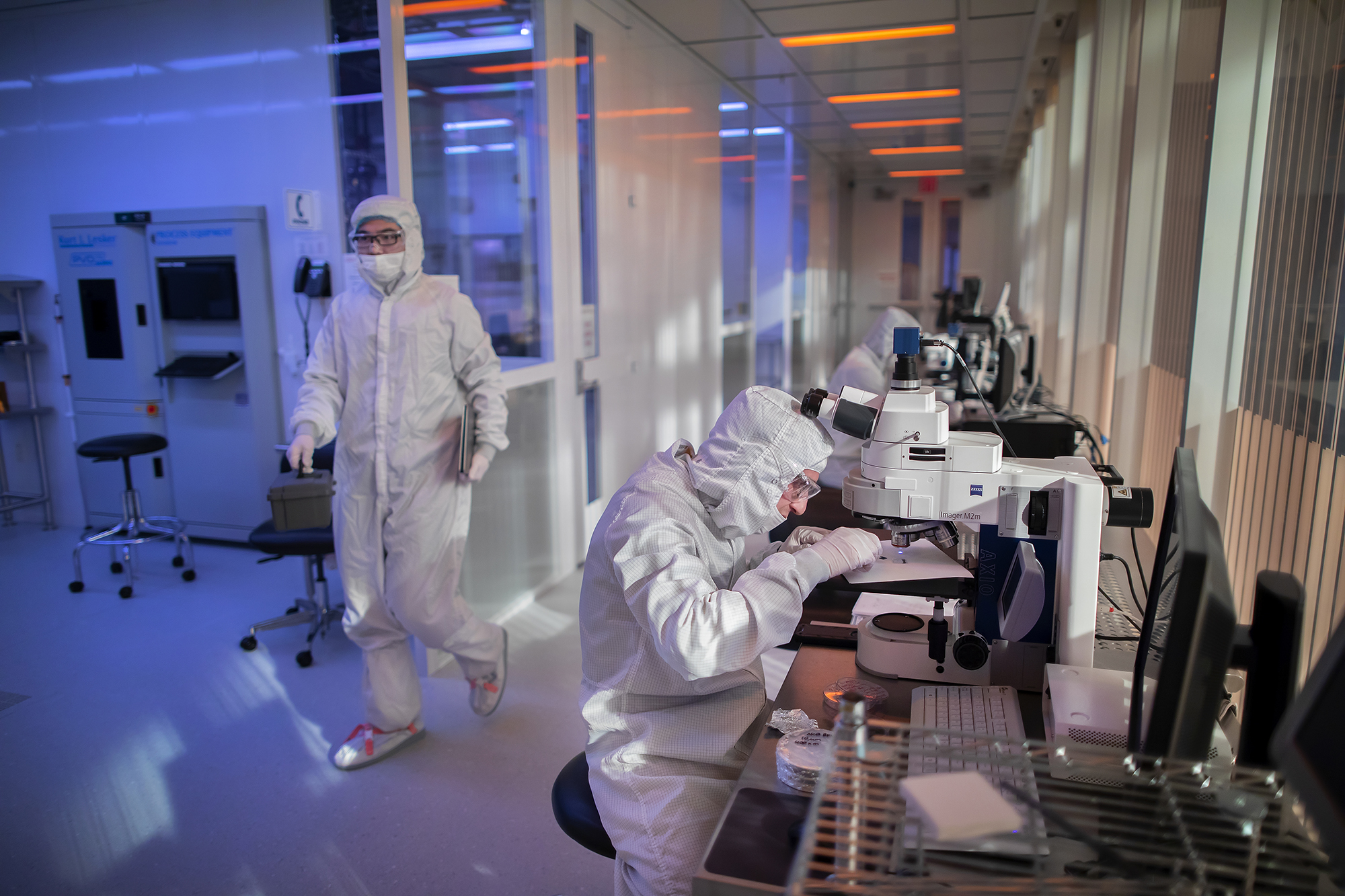 singh center workers in clean room suits