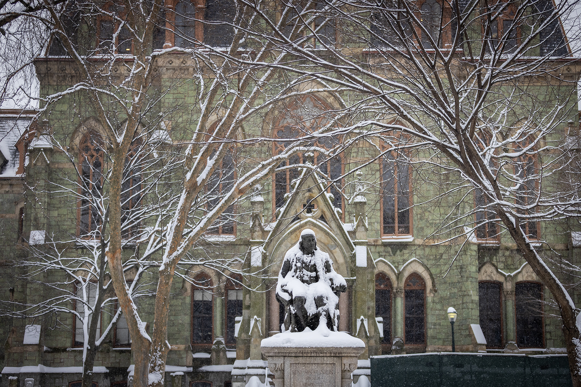 snow on ben franklin in front of college hall