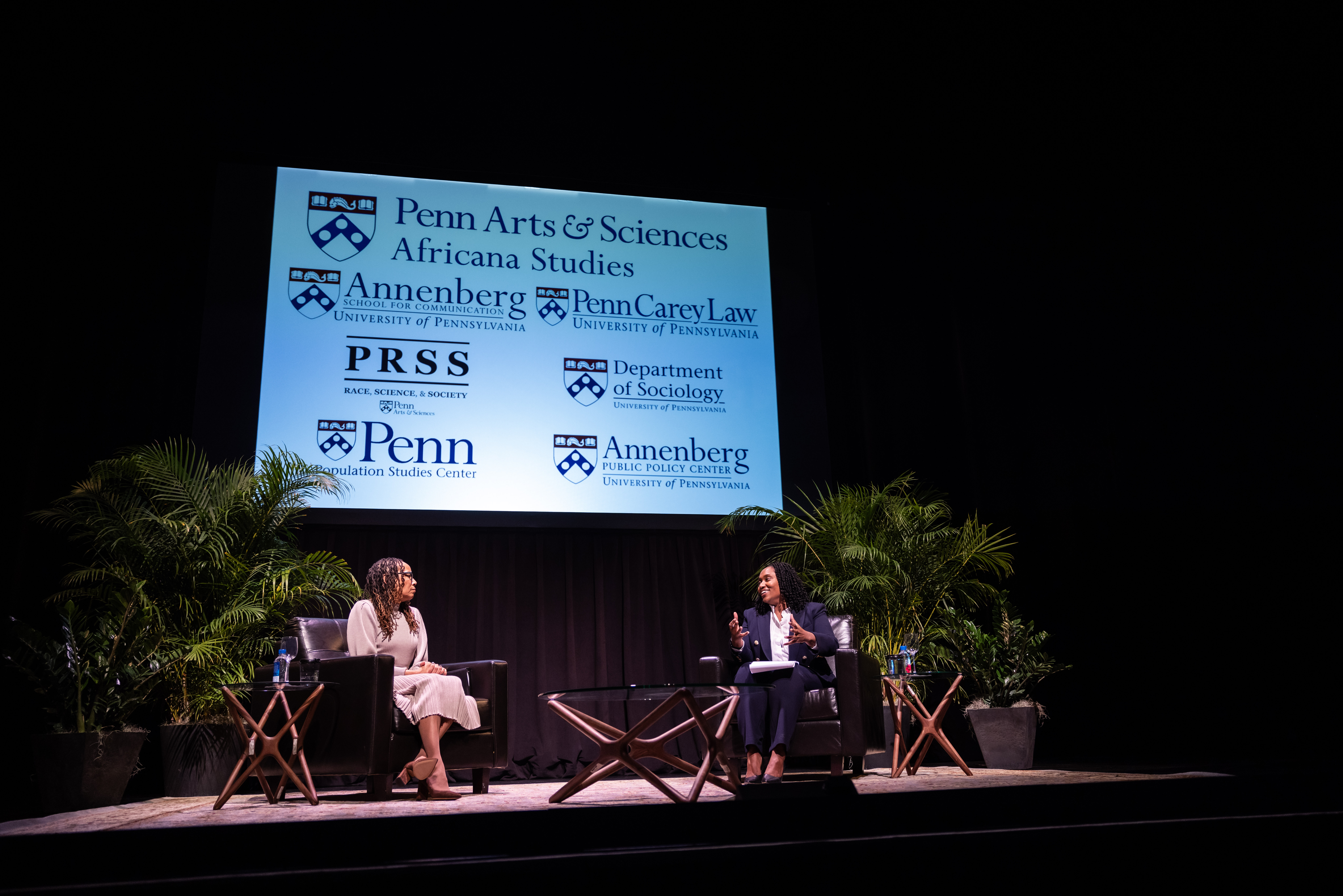 Dorothy Roberts and Marcia Chatelain sit under a screen with logos from Penn Arts & Sciences, Annenberg, Penn Carey Law, PRSS, and the Department of Sociology