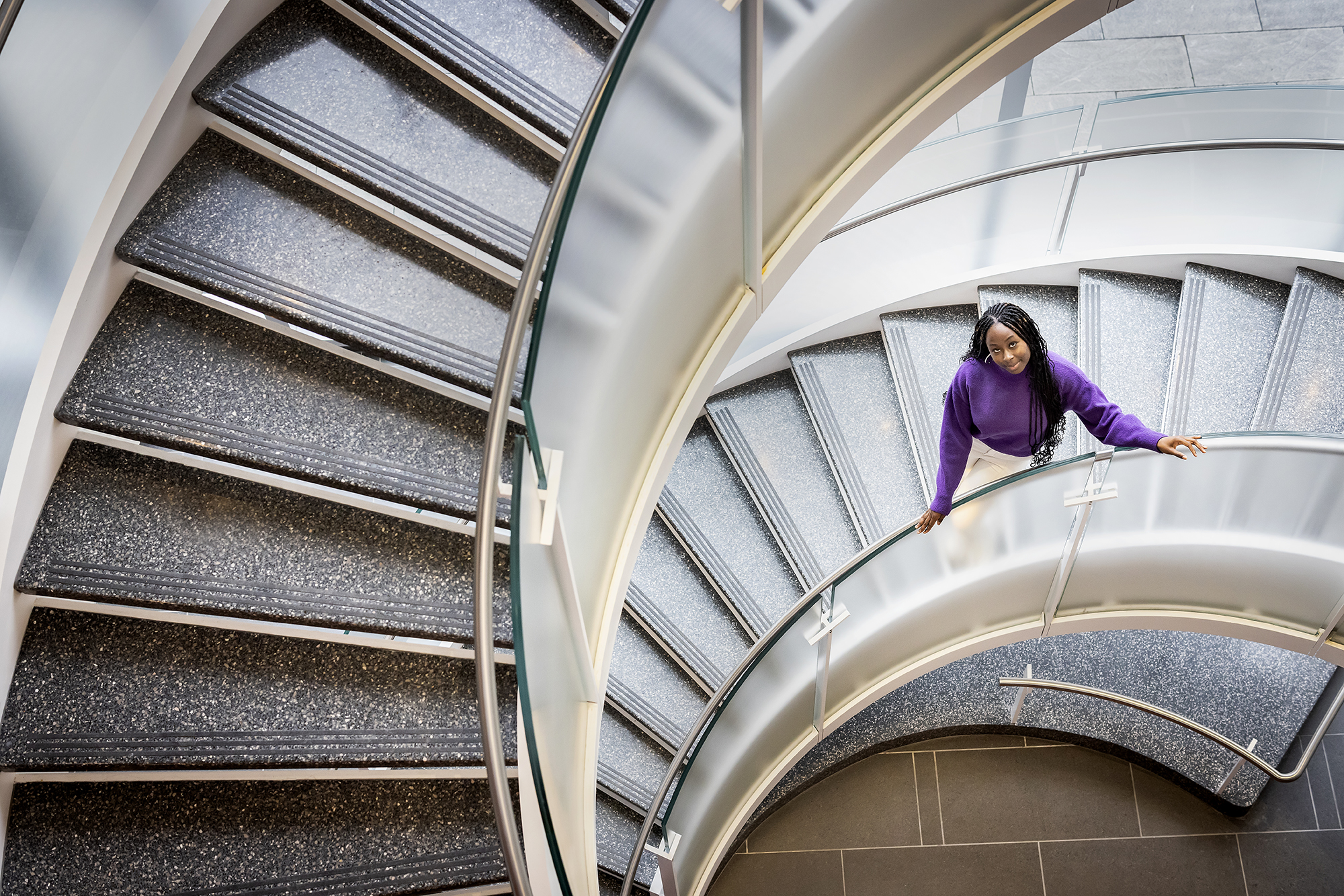 Taussia Boadi looks up from the winding staircase in the Wharton Academic Research Building.