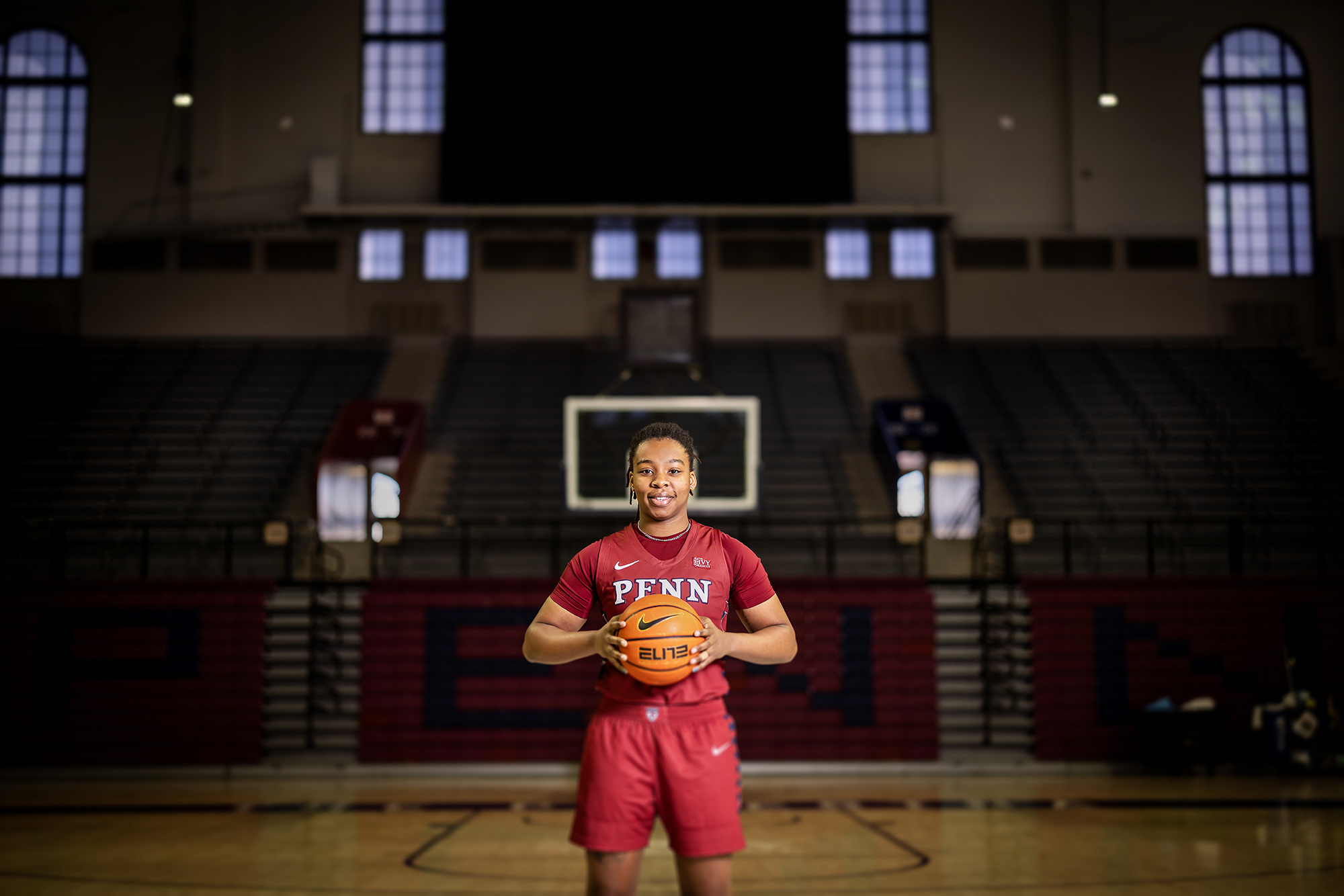 At The Palestra, Jordan Obi poses at mid-court with the ball in her hands.