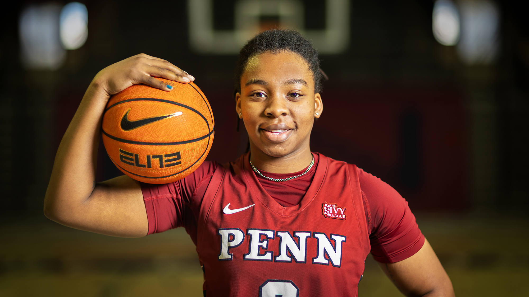 Jordan Obi poses with a ball on her right shoulder.