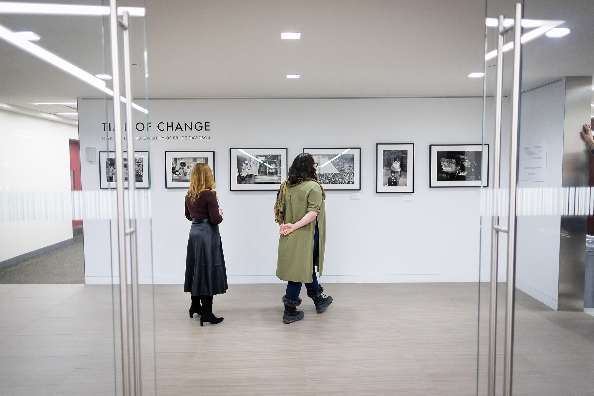 two people looking at the Time of Change photo exhibition