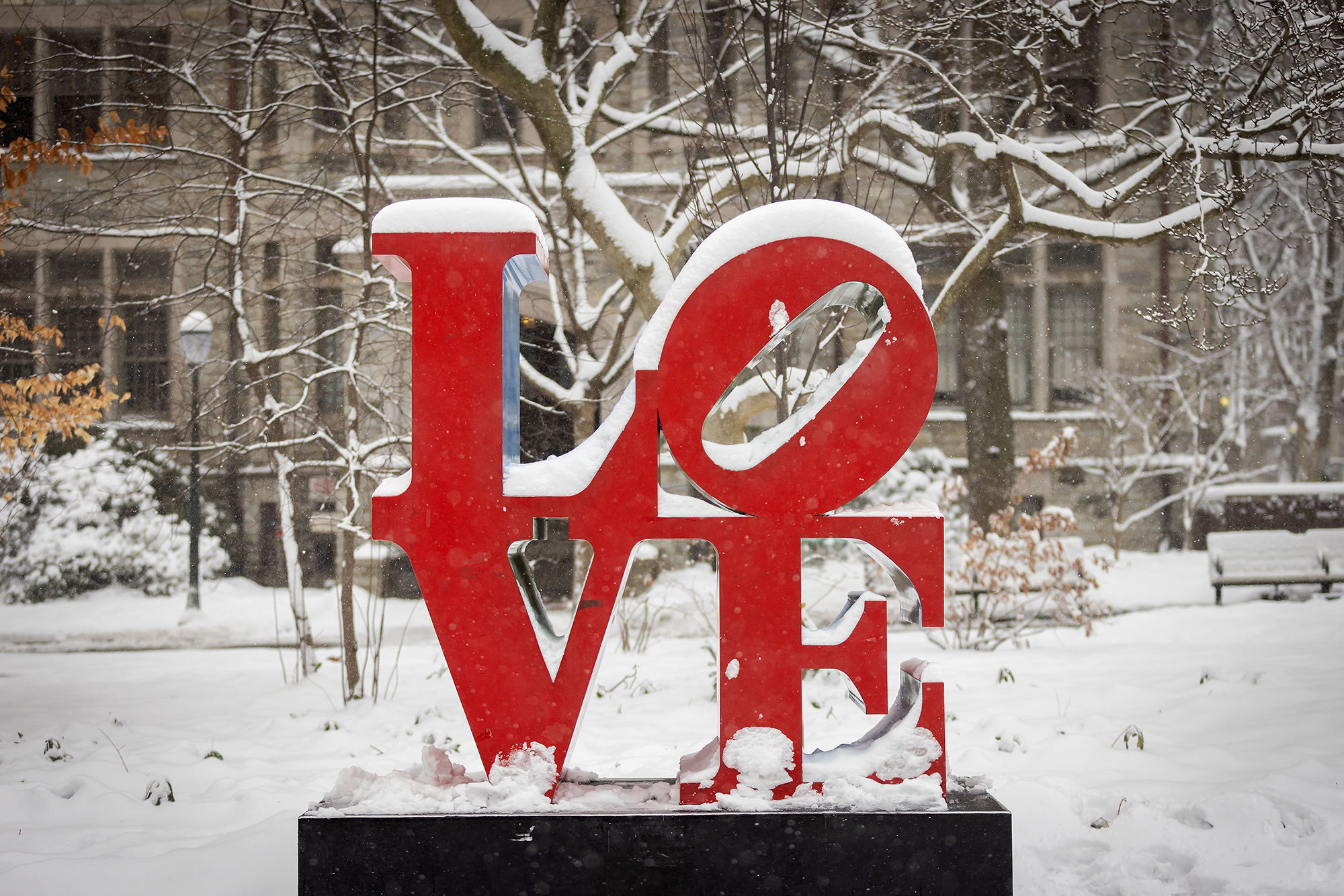Robert Indiana’s LOVE statue on Penn’s campus in snow in the winter.