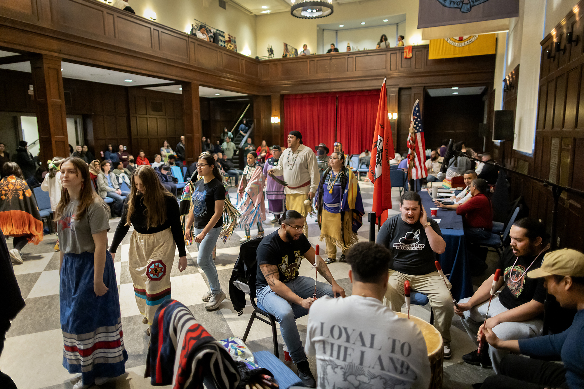 The hall of flags pictured with intertribal dancers and musicians