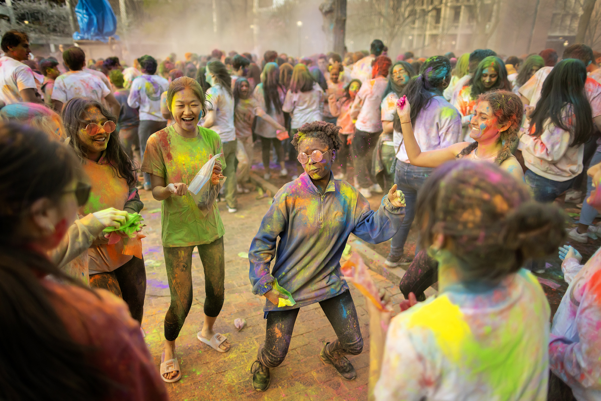 A group of students with colored powder on them at Holi