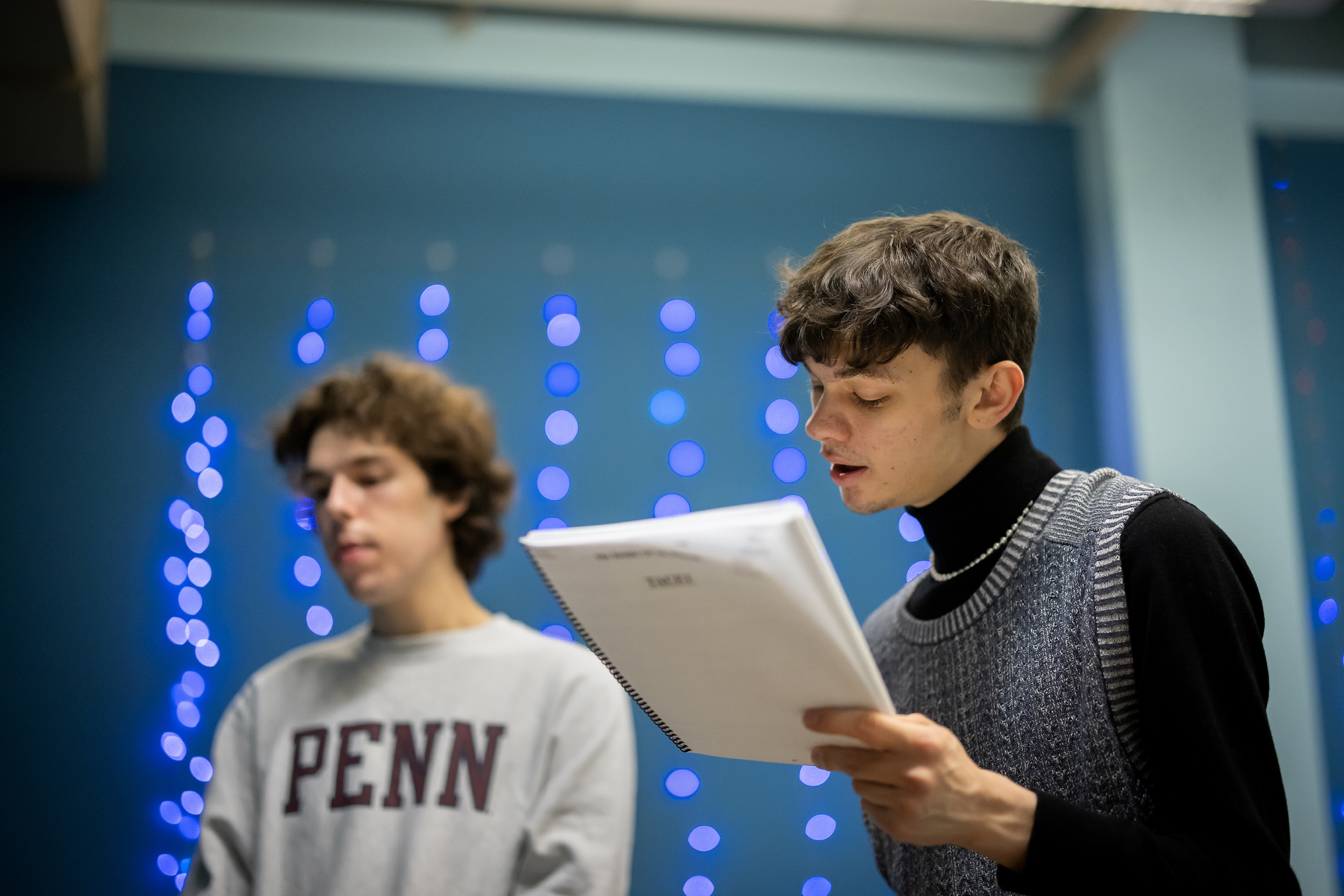 Two members of a Penn singing group rehearsing.
