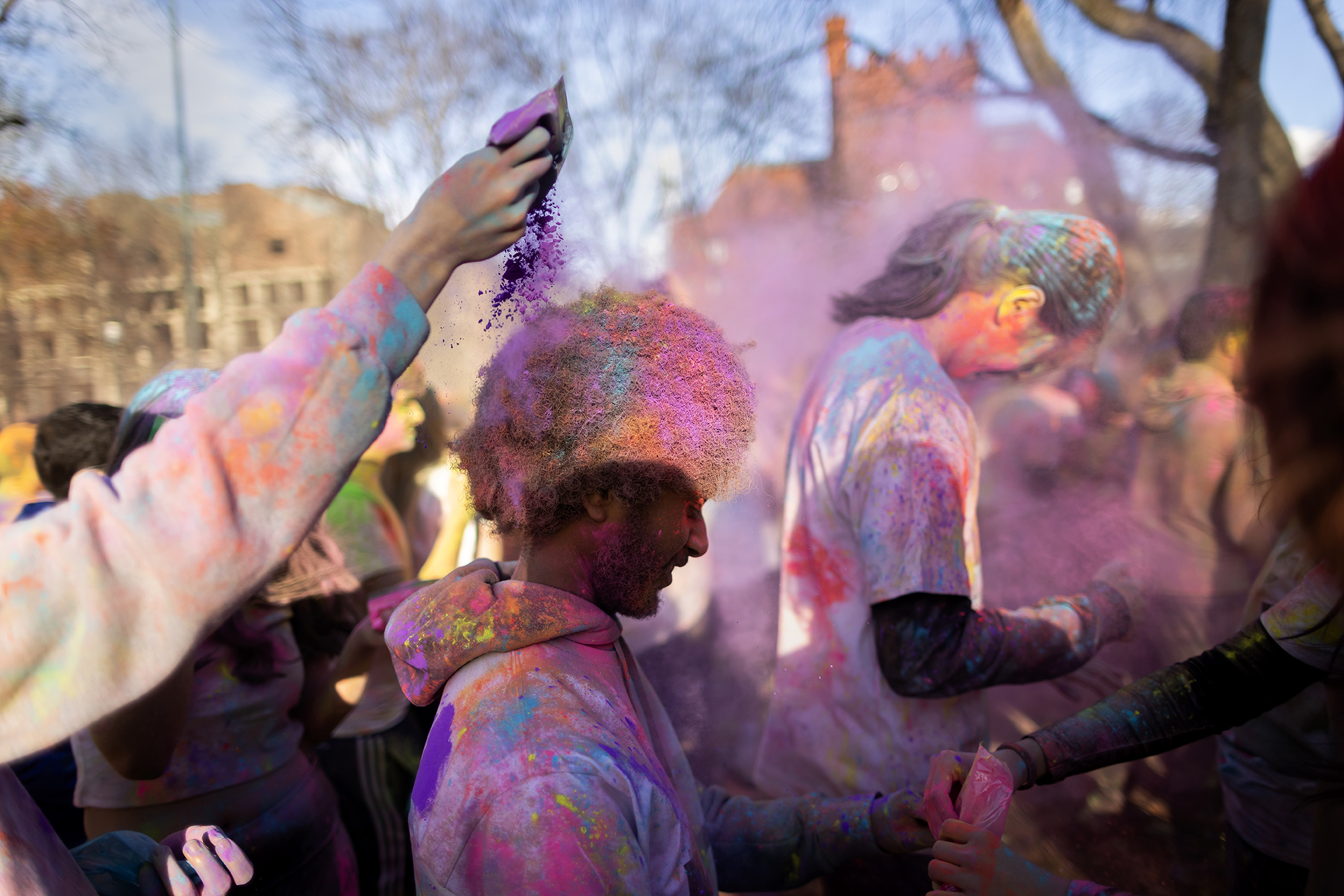 A Penn student pours powder onto the hair of another Penn student during the Holi celebration.