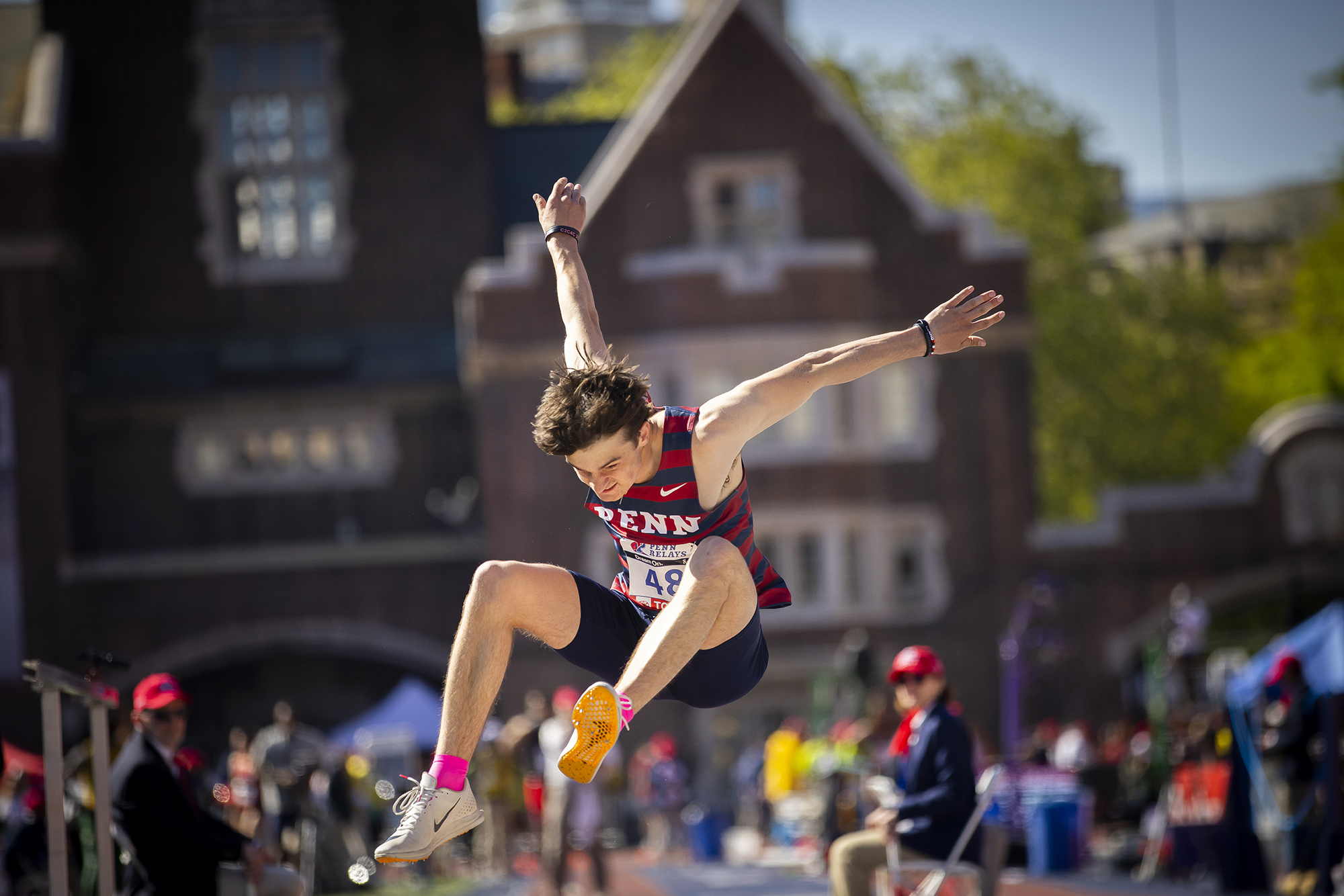 student athlete competes in the long jump during the penn relays