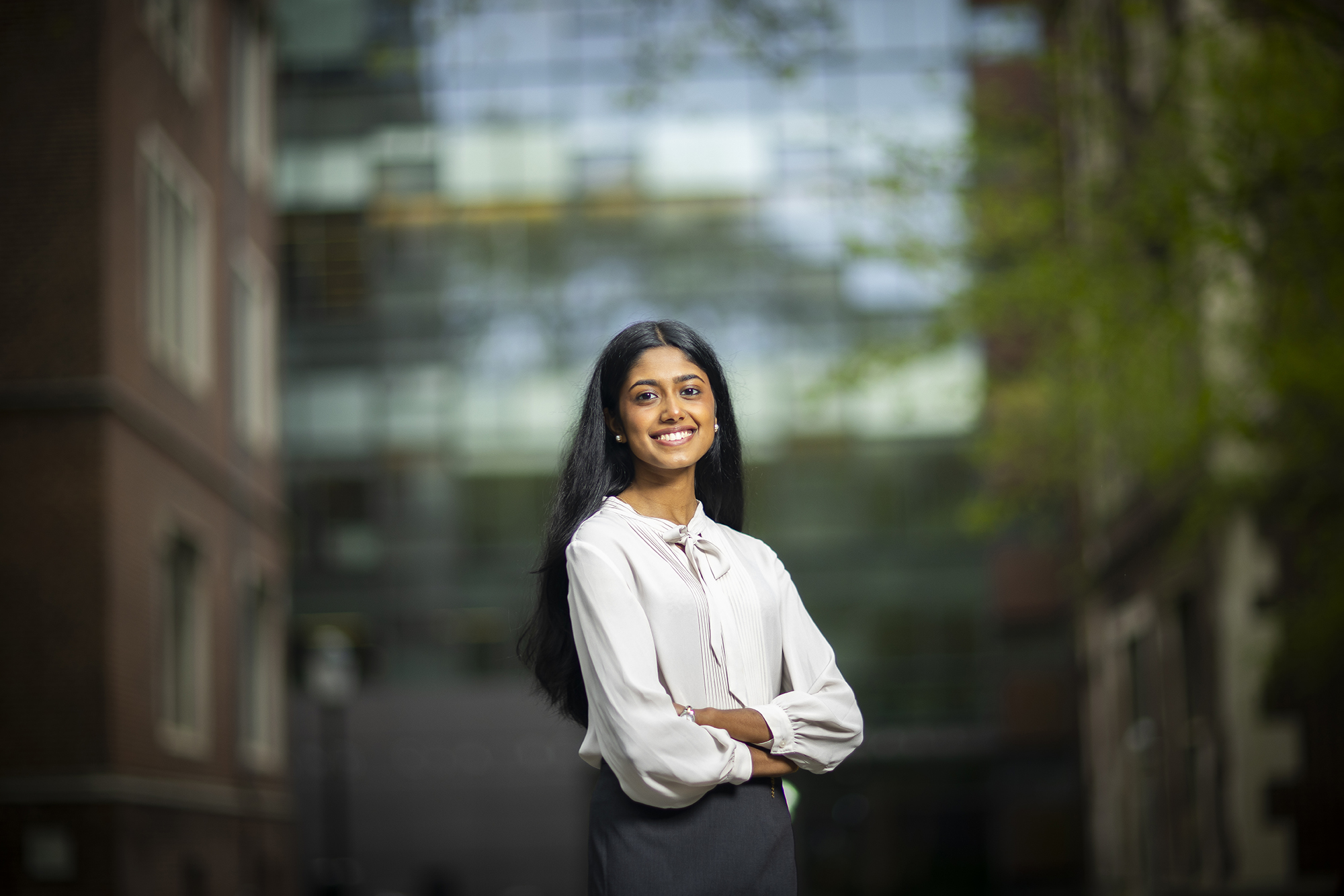 Penn fourth-year Gauthami Moorkanat poses with her arms crossed outside Fisher-Bennett Hall on Penn campus.