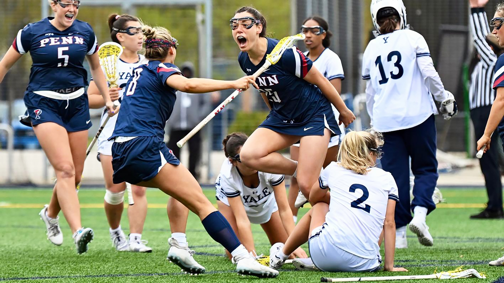 Players on the women's lacrosse team celebrate after scoring a goal against Yale.