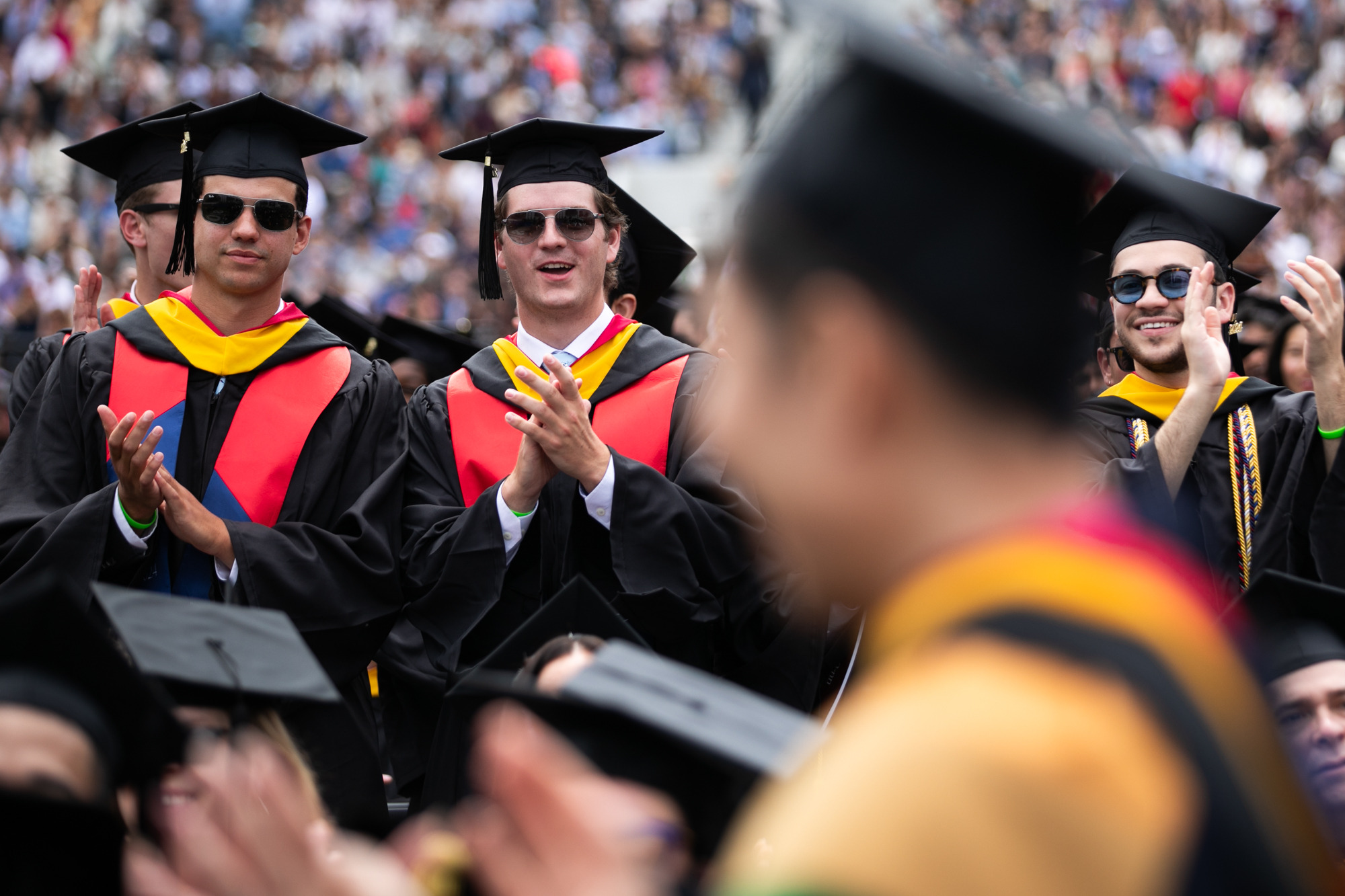 students clap during commencement ceremony