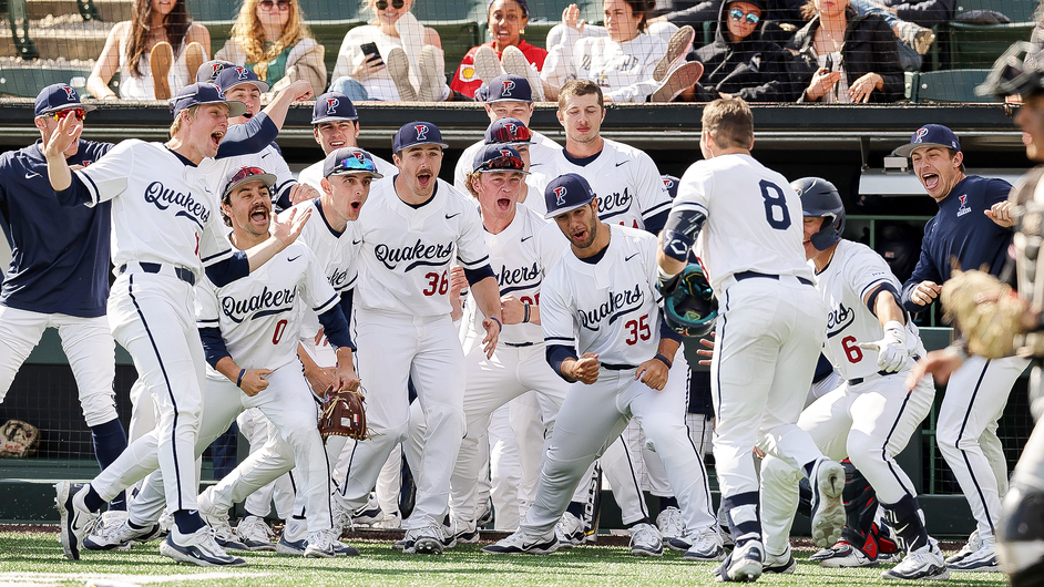 Members of the baseball team celebrate at home plate after a big play.