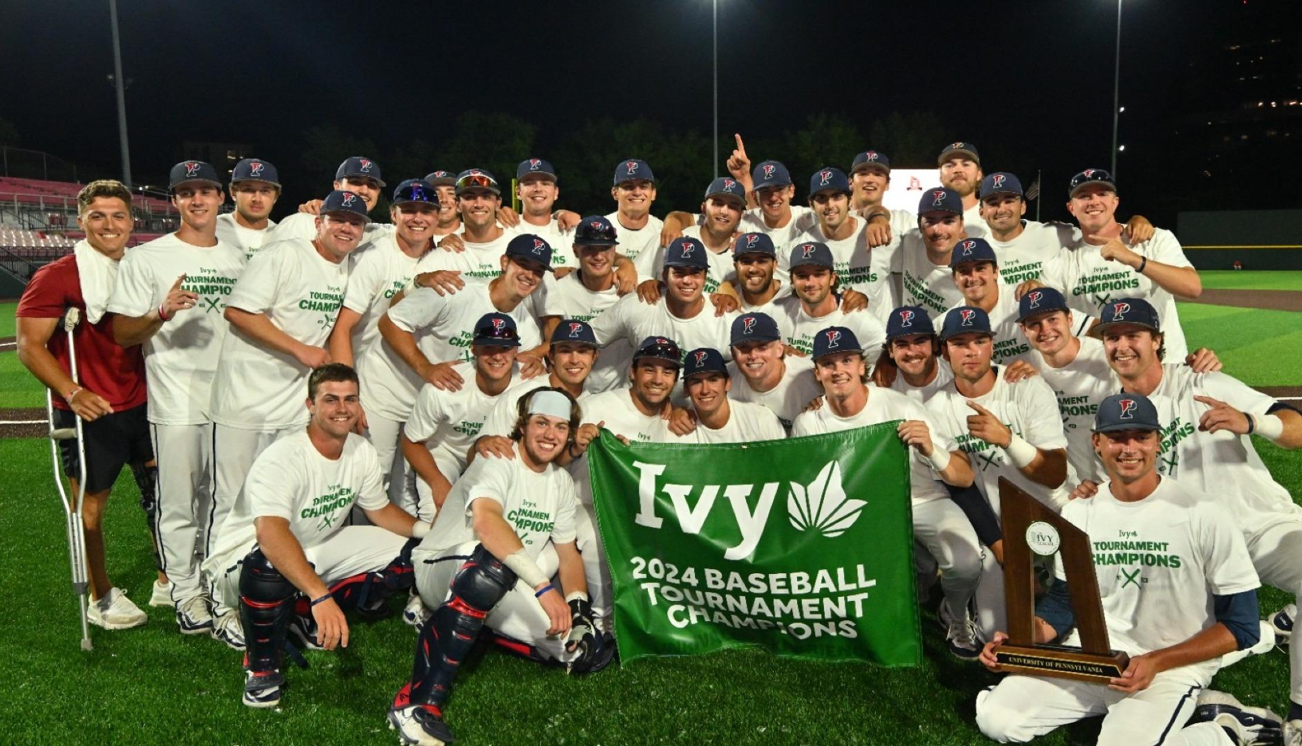 Members of the baseball team pose with the Ivy Tournament championship banner.