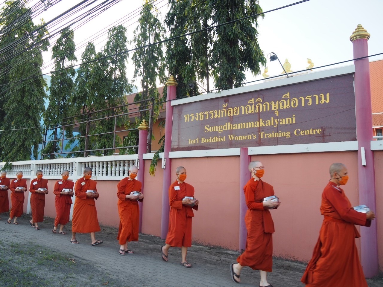 Katherine Scahill and other novice female monks walk near the monastery in Thailand.