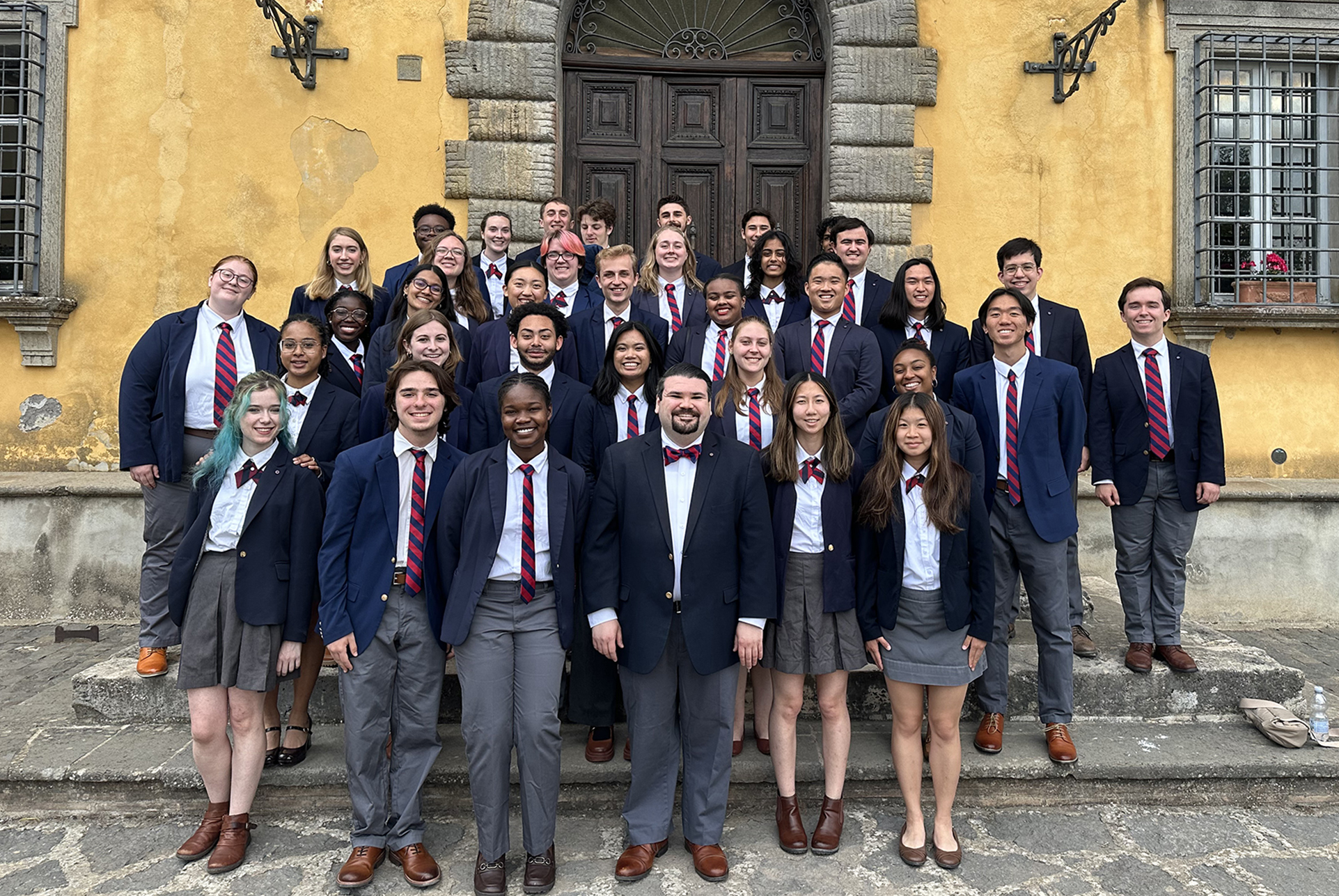 Members of the Penn Glee Club and its director in uniform in Italy.