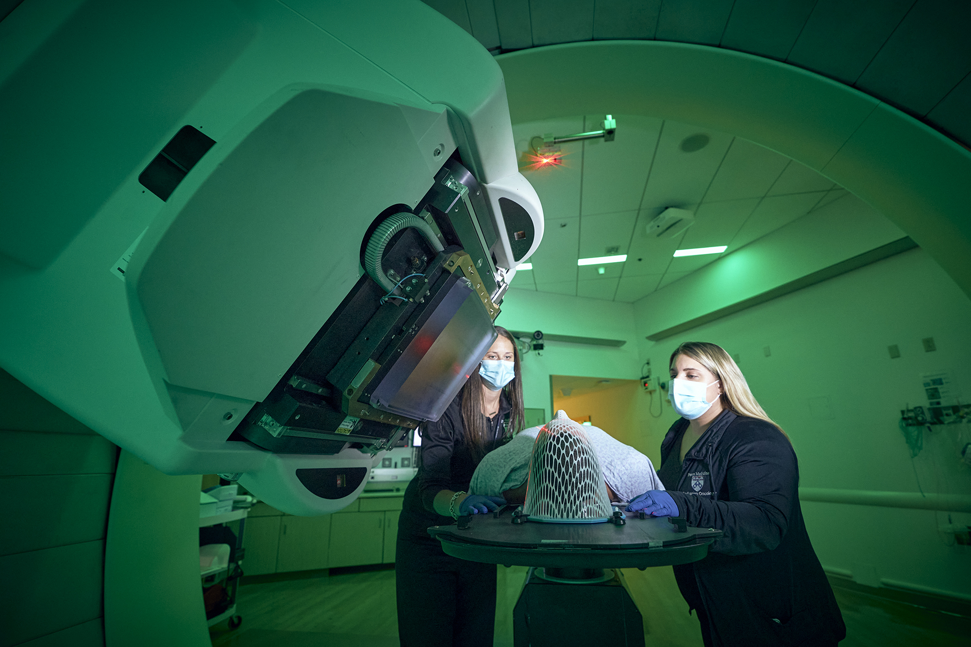 Two medical professionals and a patient having a scan.