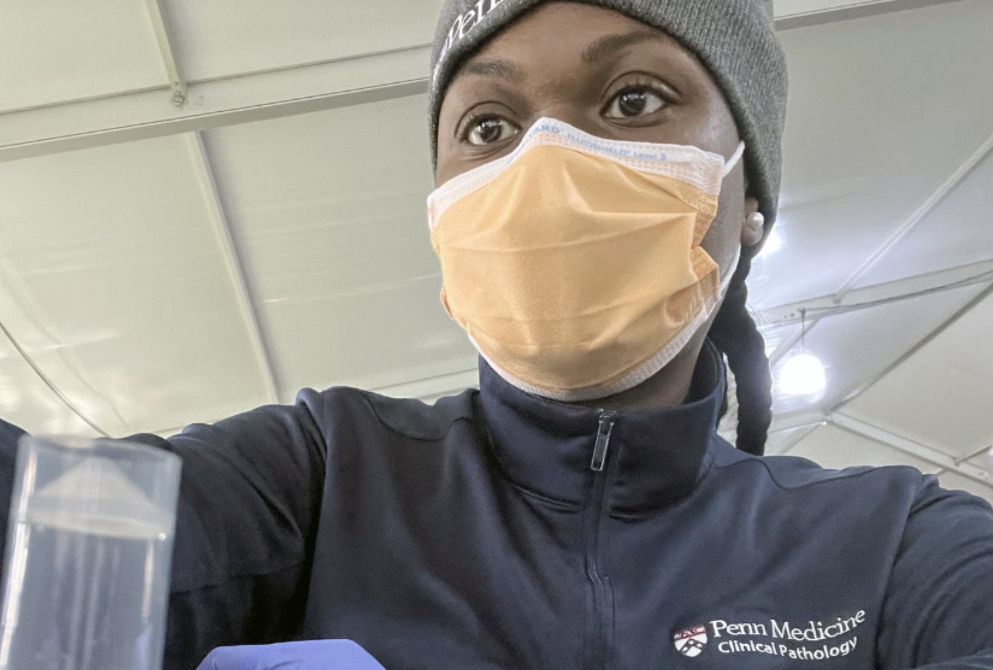 A medical professional at work wearing a mask.