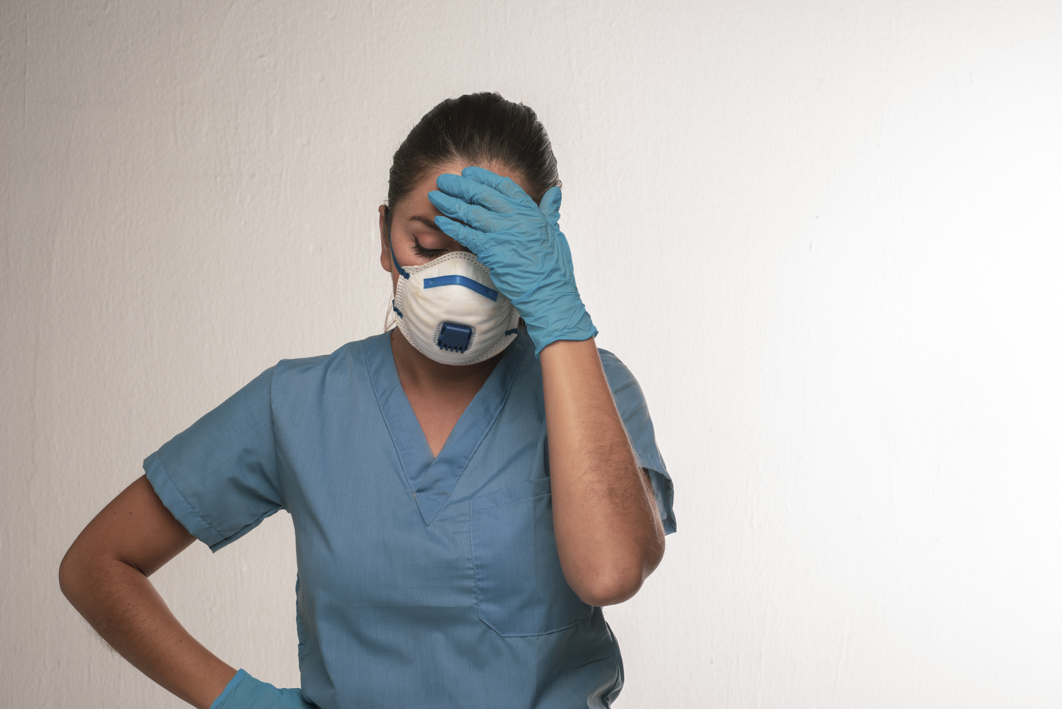 Tired-looking nurse wearing mask.