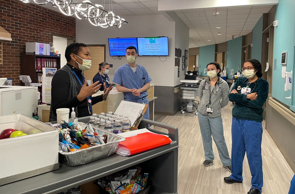 Kenya Pitt speaks to staff members at Penn Medicine.