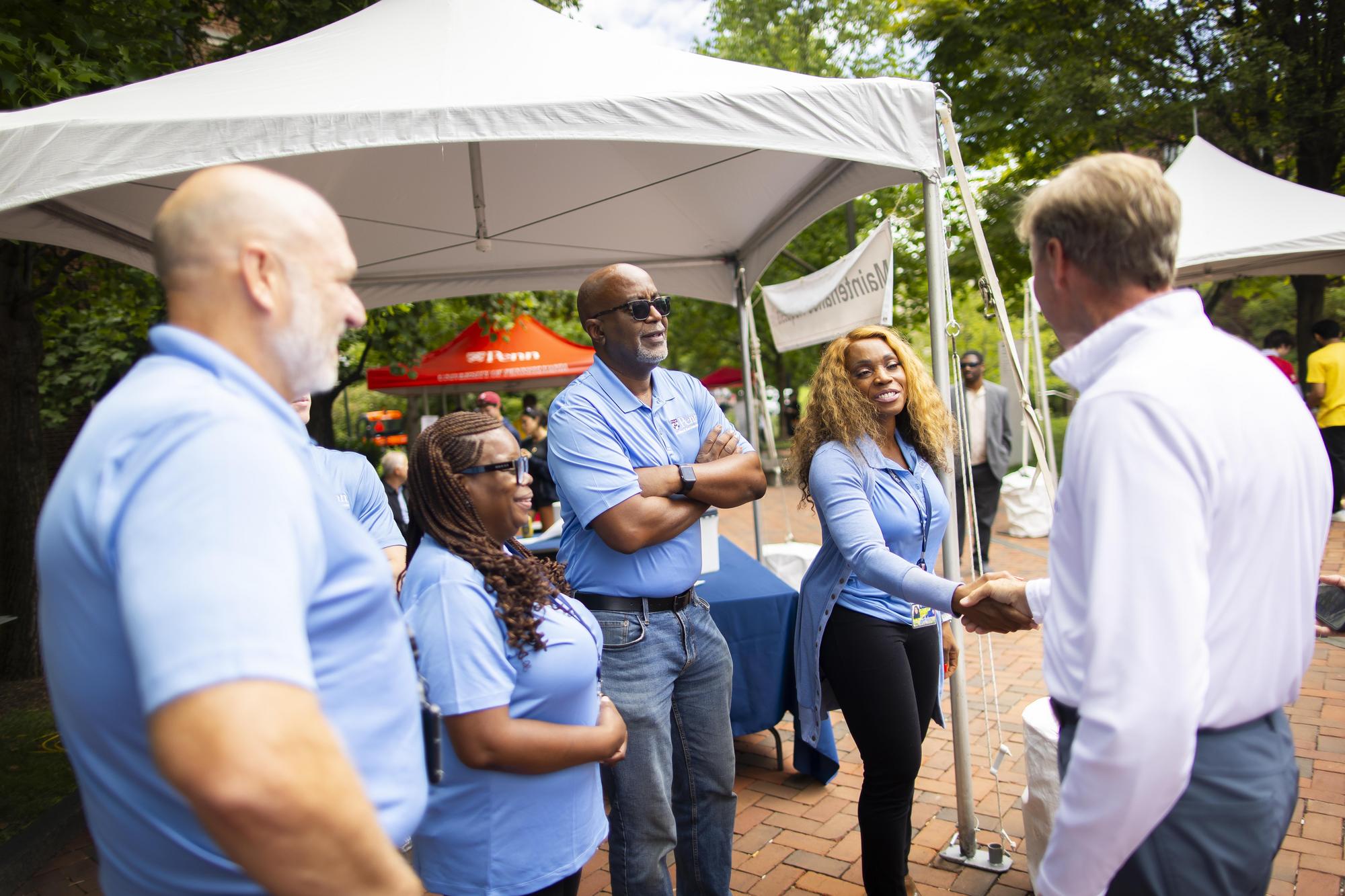 Penn President J. Larry Jameson shakes hands with Move-In coordinators on campus during Move-In.