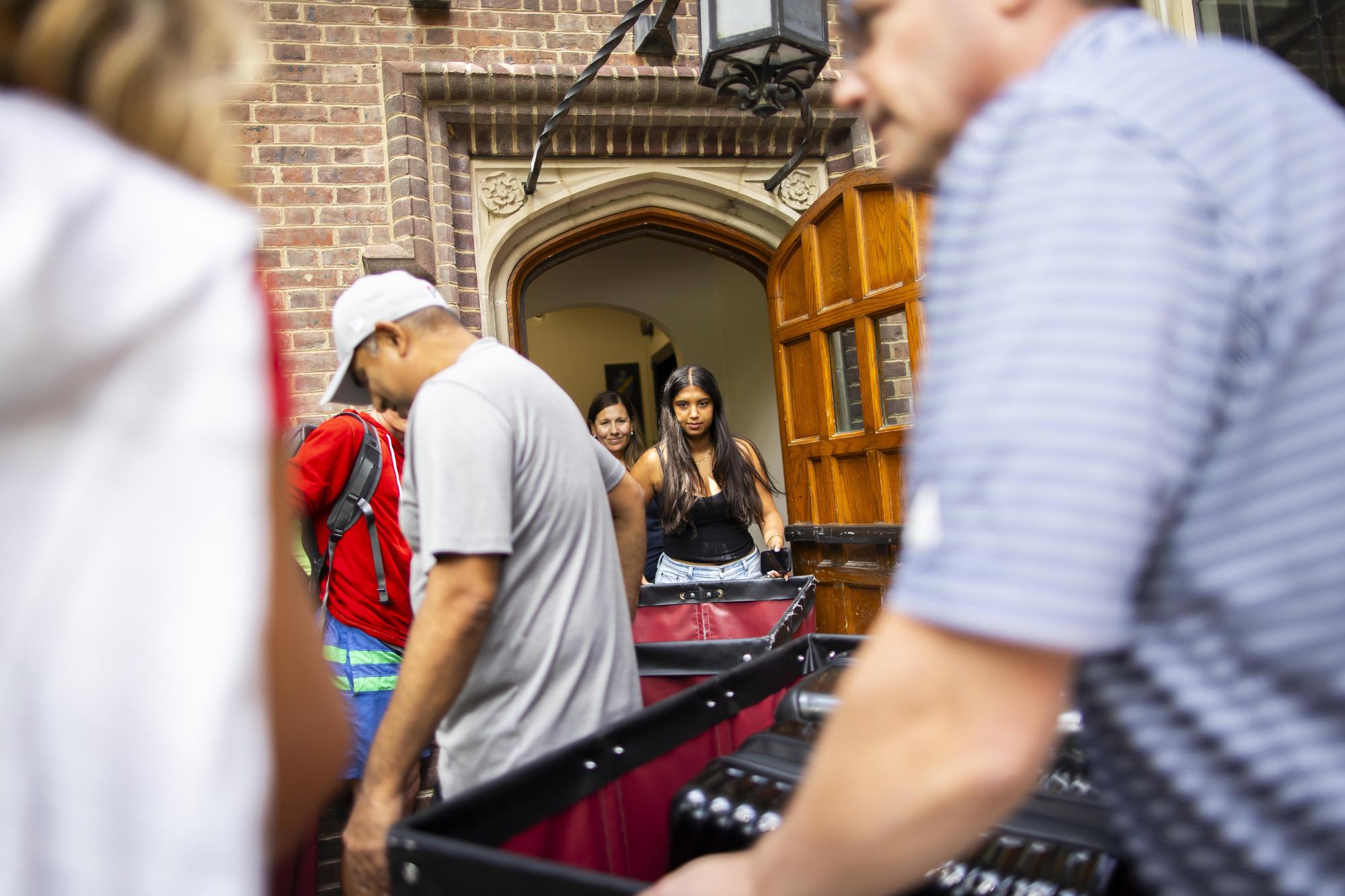 Students and their parents with Move-In carts outside a dorm on Move-In day.