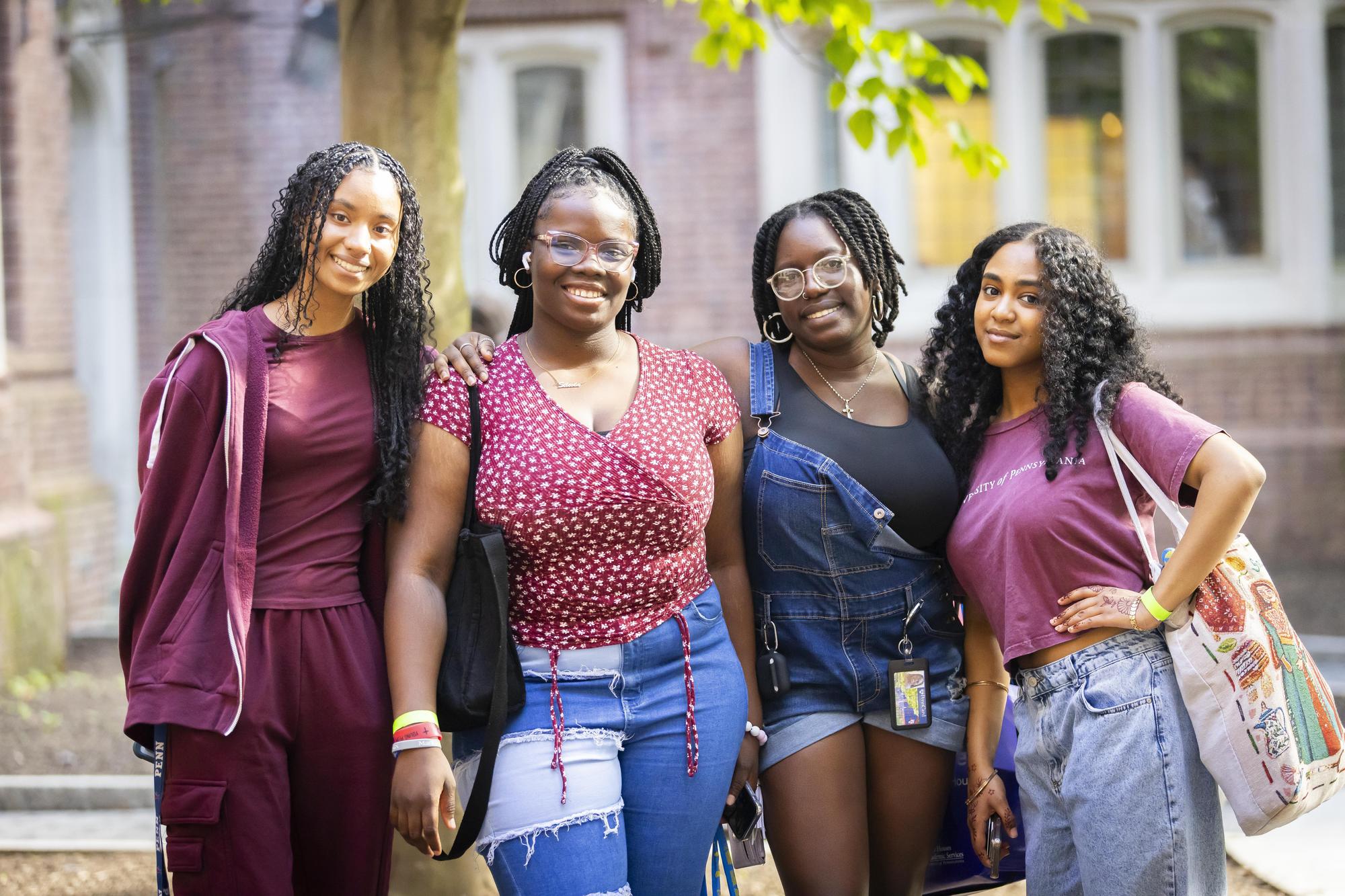 Four people posing for a photo on Penn’s Move-In day.