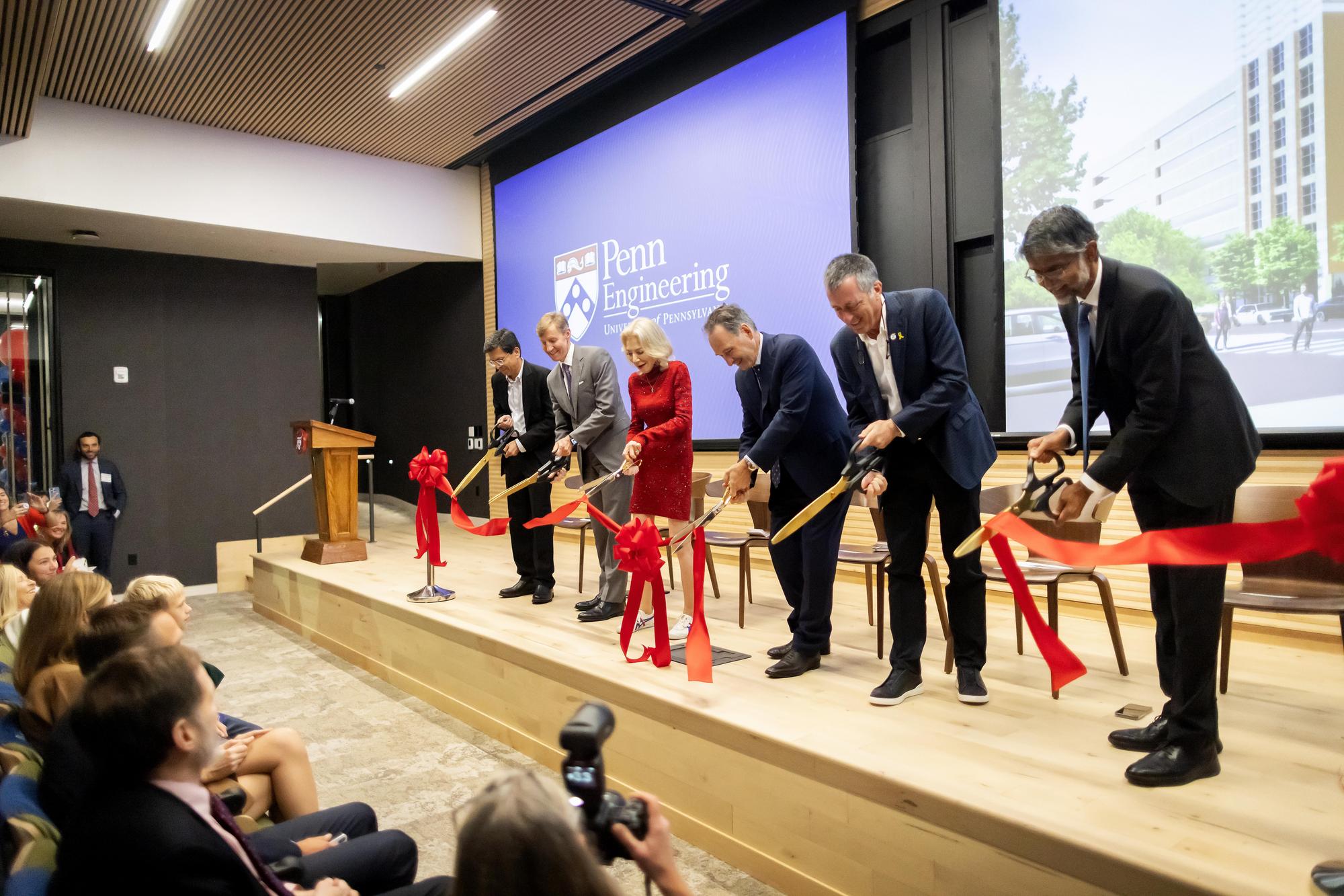 Ramanan Raghavendran, J. Larry Jameson, Amy Gutmann, Harlan Stone, Rob Stavis, Chair of the Penn Engineering Board of Advisors and Vijay Kumar cut the red ribbon.